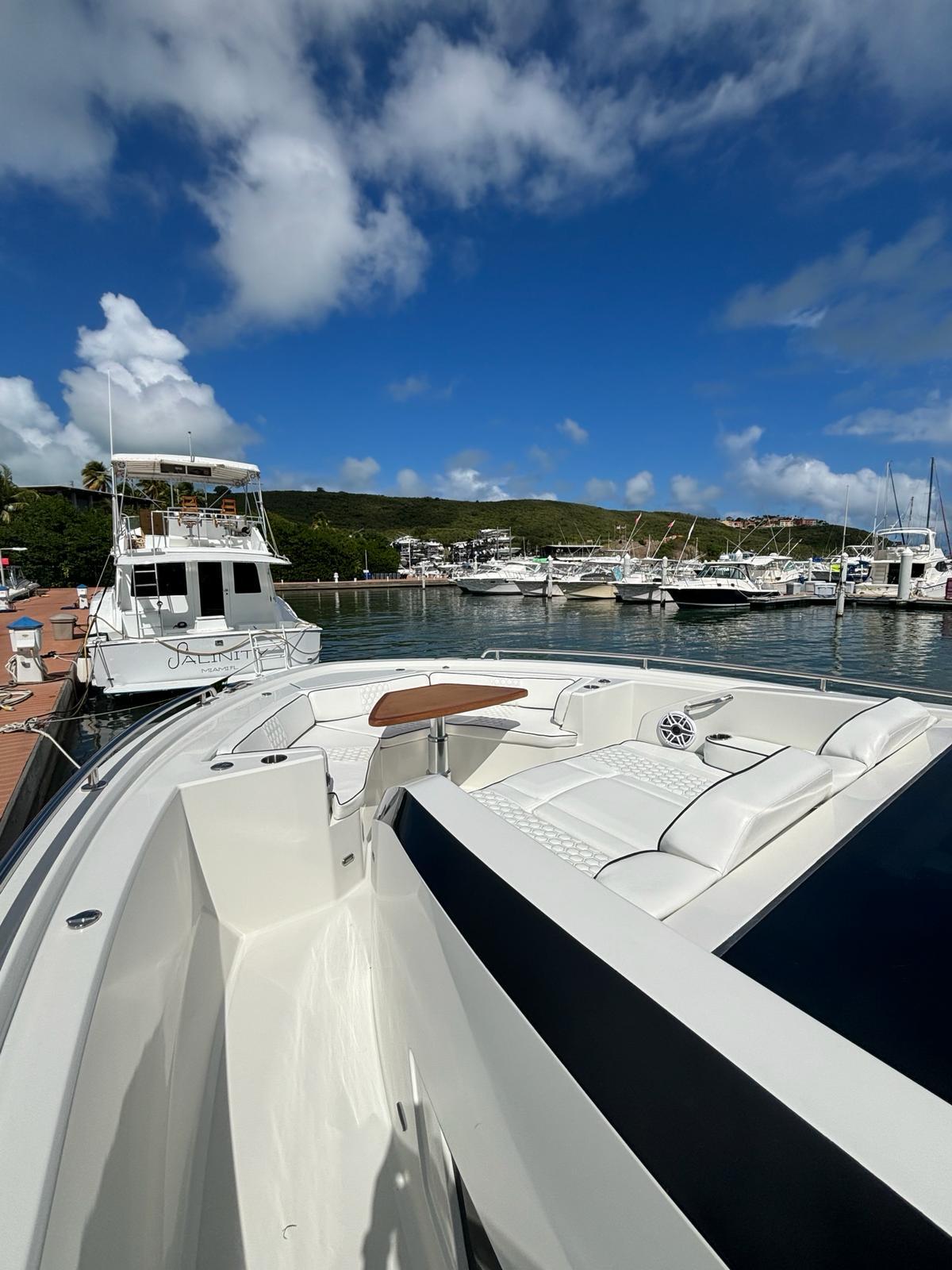 2020 Ocean Alexander 45 Divergence yacht docked at a marina under a blue sky.