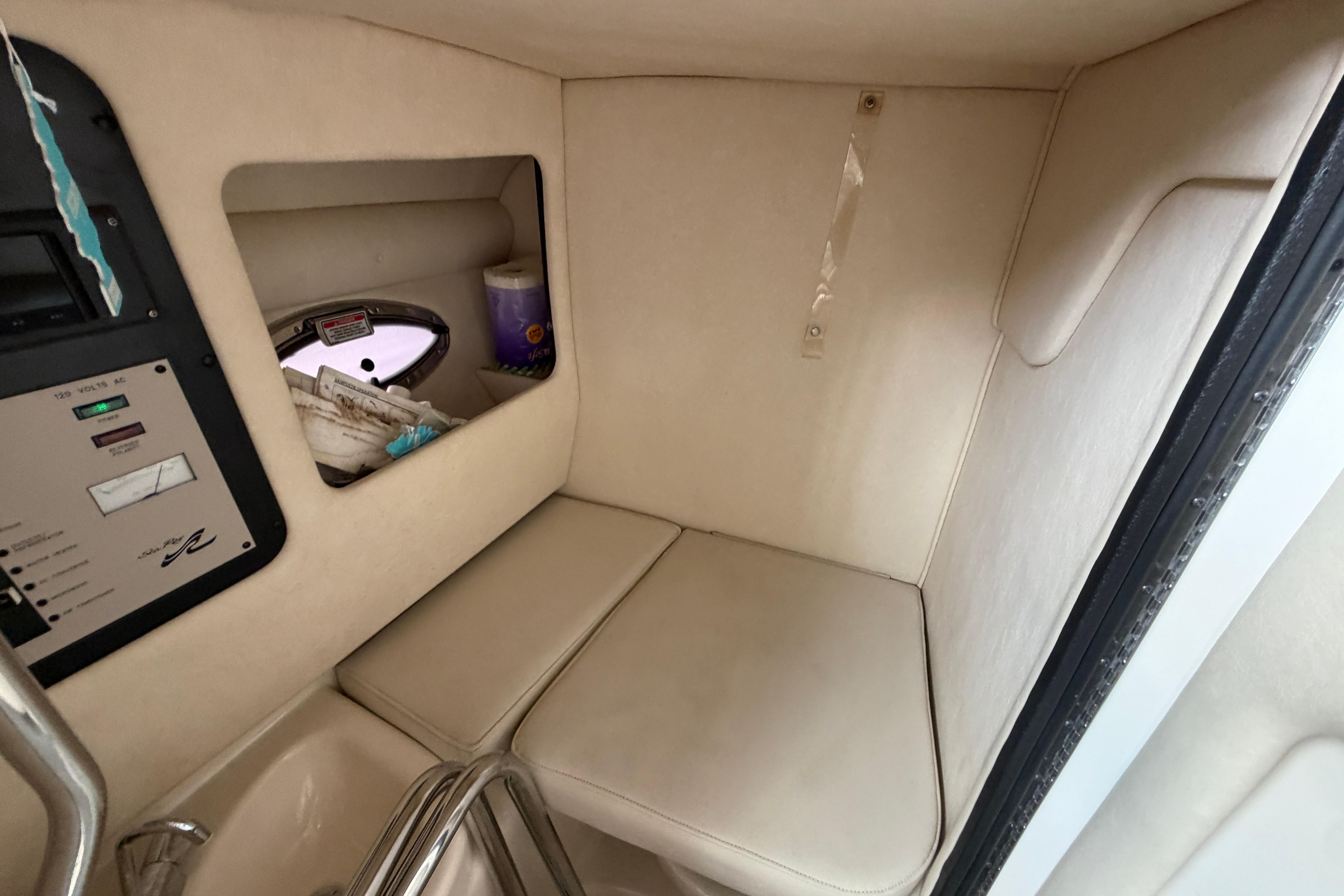 2003 Sea Ray 290 Bowrider cabin interior with seating and control panel.