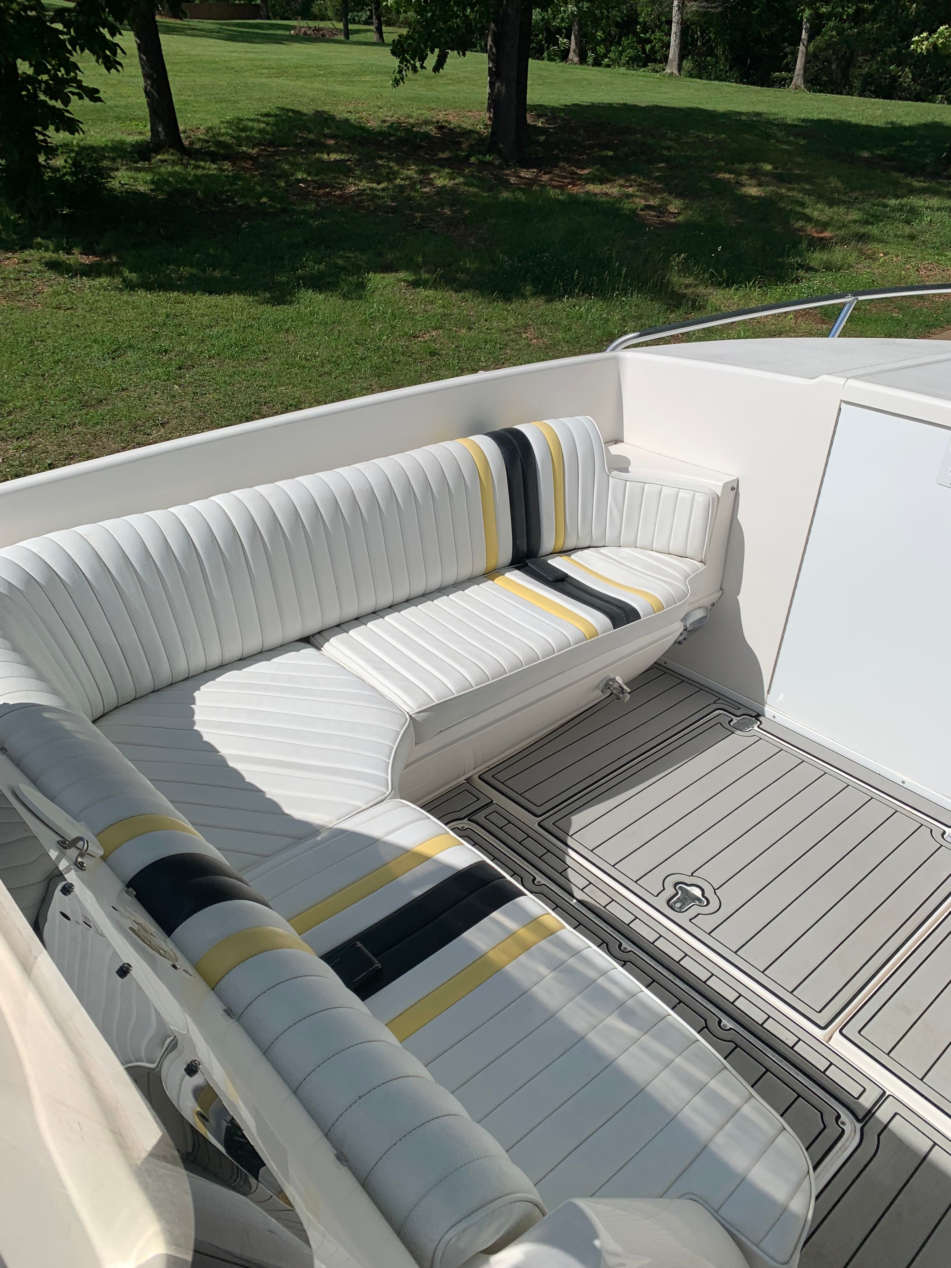 Intrepid 322 Cuddy Center Console, seating area with striped upholstery.