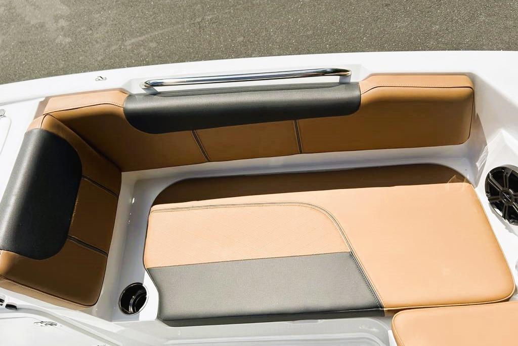 Luxurious seating area on 2026 Tahoe 2150 boat with tan and black upholstery.