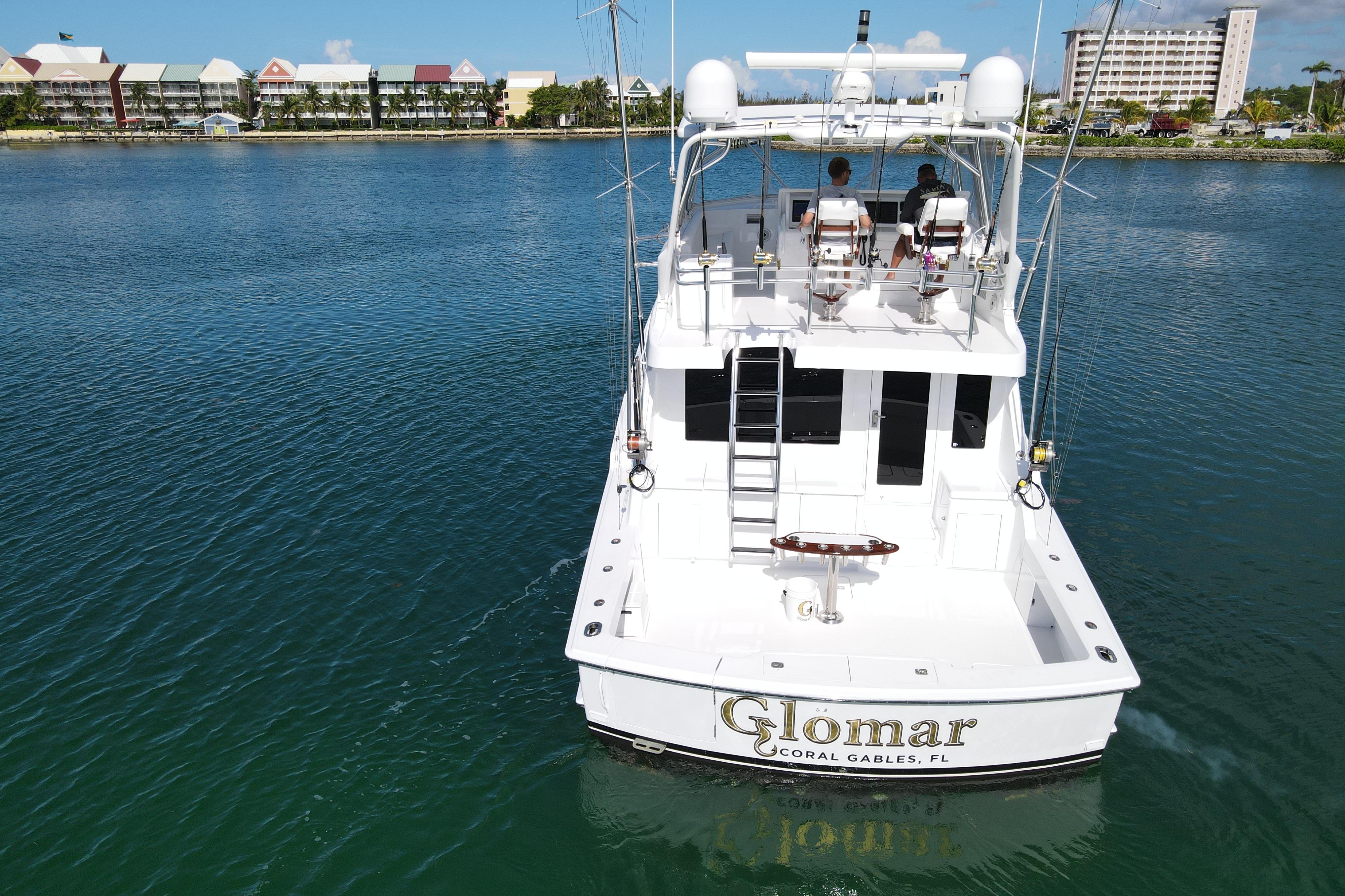 2004 Hatteras 60 Convertible yacht on water, rear view, Coral Gables, Florida.