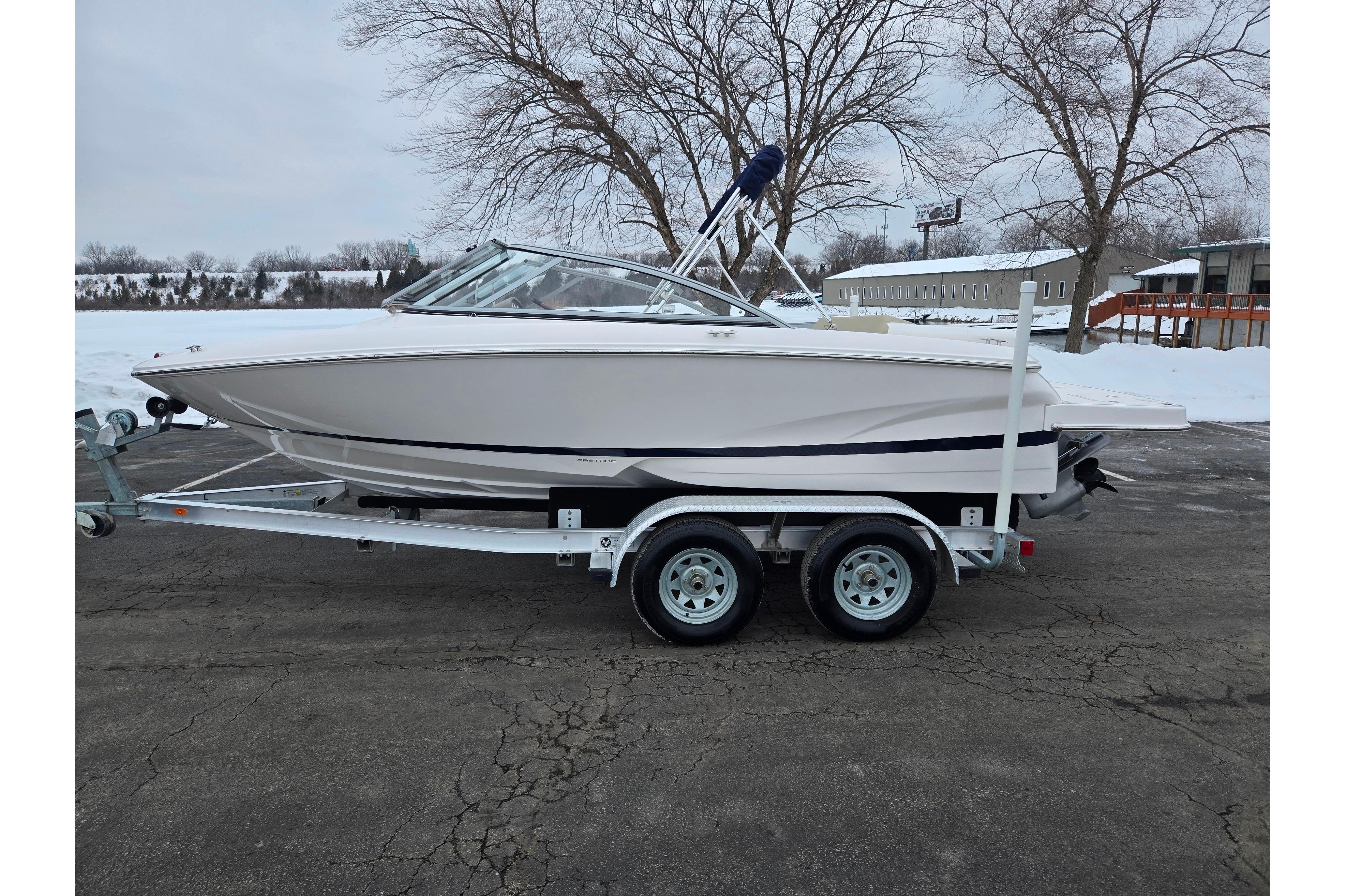 2015 Regal 1900 ES Bowrider on trailer, parked in snowy outdoor setting.