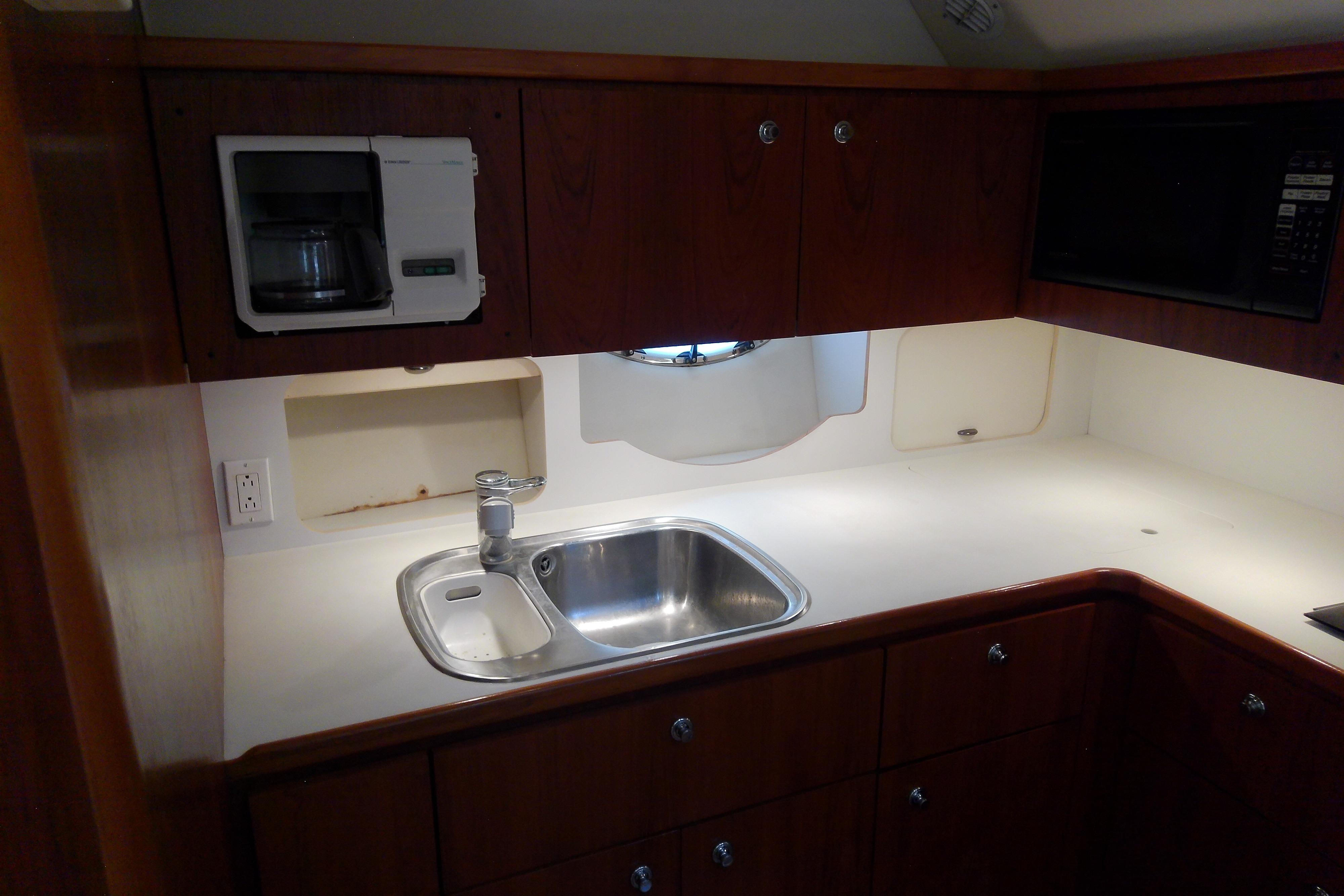 2000 Tiara Yachts 4100 Open galley with sink, microwave, and coffee maker.