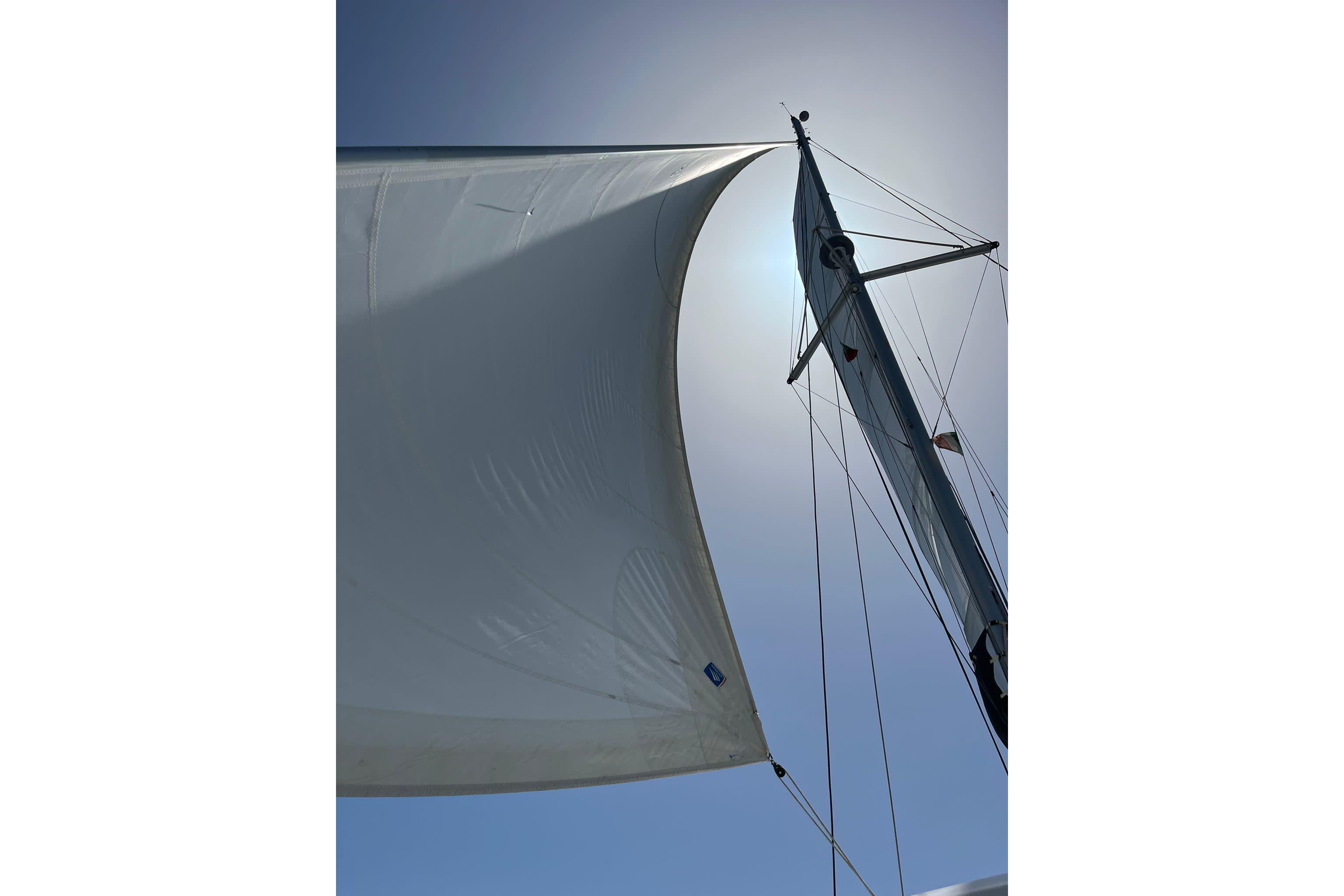 Sail of a 2020 Lagoon 42 catamaran against a bright sky.