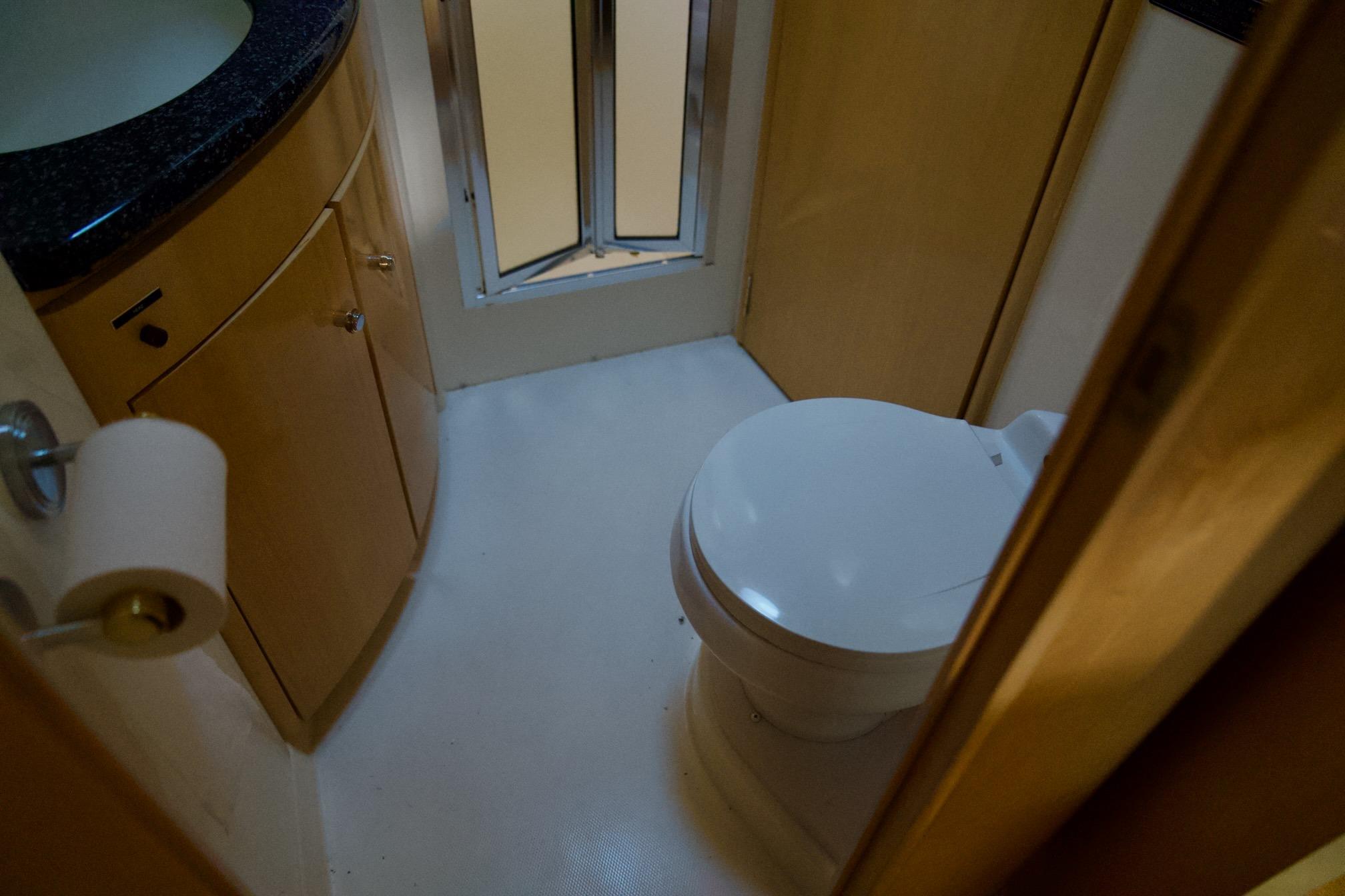 Bathroom interior of 2000 Carver 506 Motor Yacht with toilet and sink.