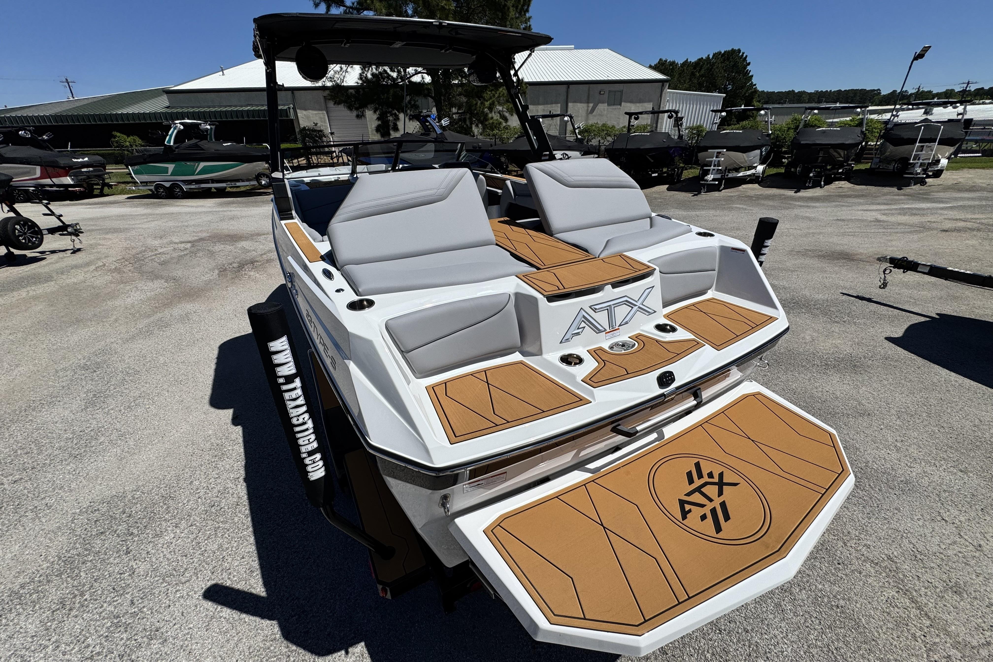 2026 ATX Surf Boats 22 Type-S with sleek design and spacious seating in a marina setting.