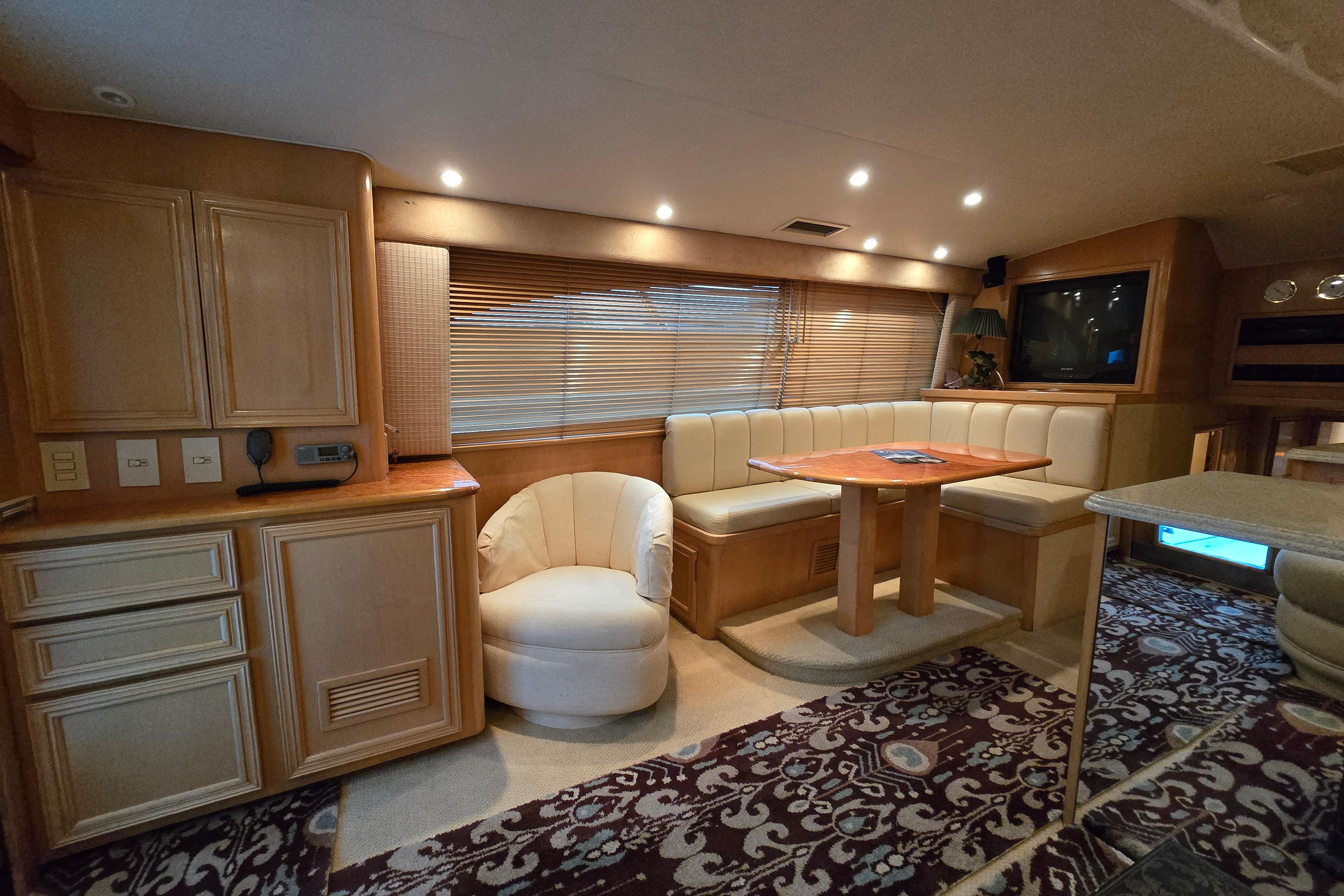 Luxurious interior of a 2001 Cavileer 53 Convertible yacht with elegant seating and cabinetry.