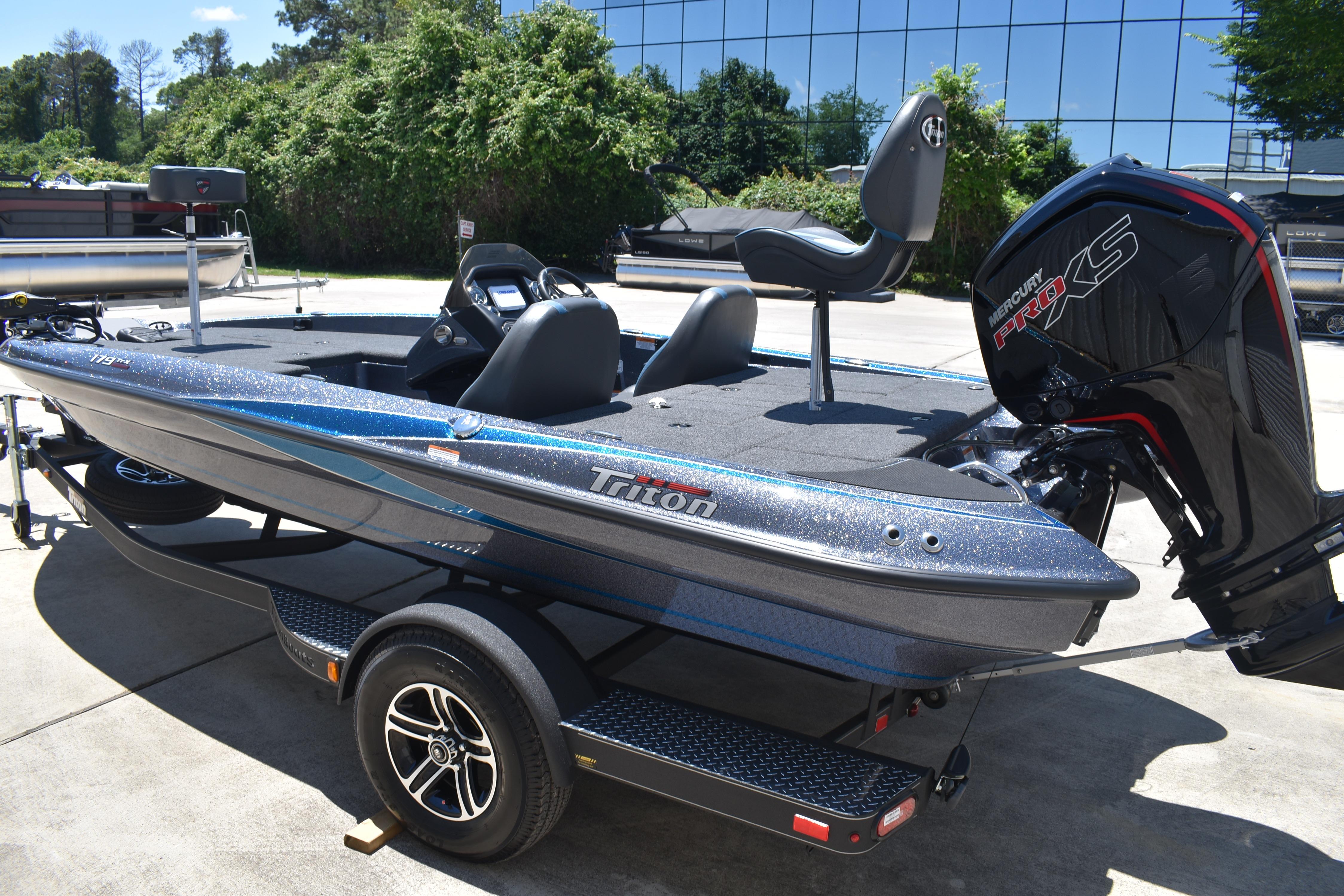 2026 Triton 179 TrX bass boat with Mercury Pro XS engine, parked outdoors.