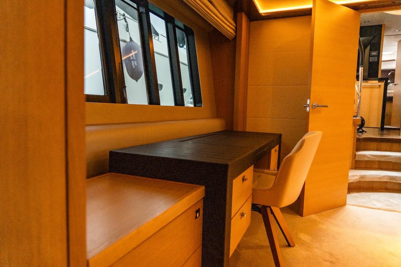 Luxurious interior of 2012 Princess V72 yacht with elegant wooden desk and chair.