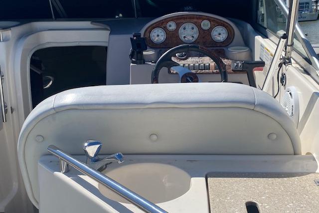 2005 Rinker Fiesta Vee 250 boat interior with steering wheel and dashboard.