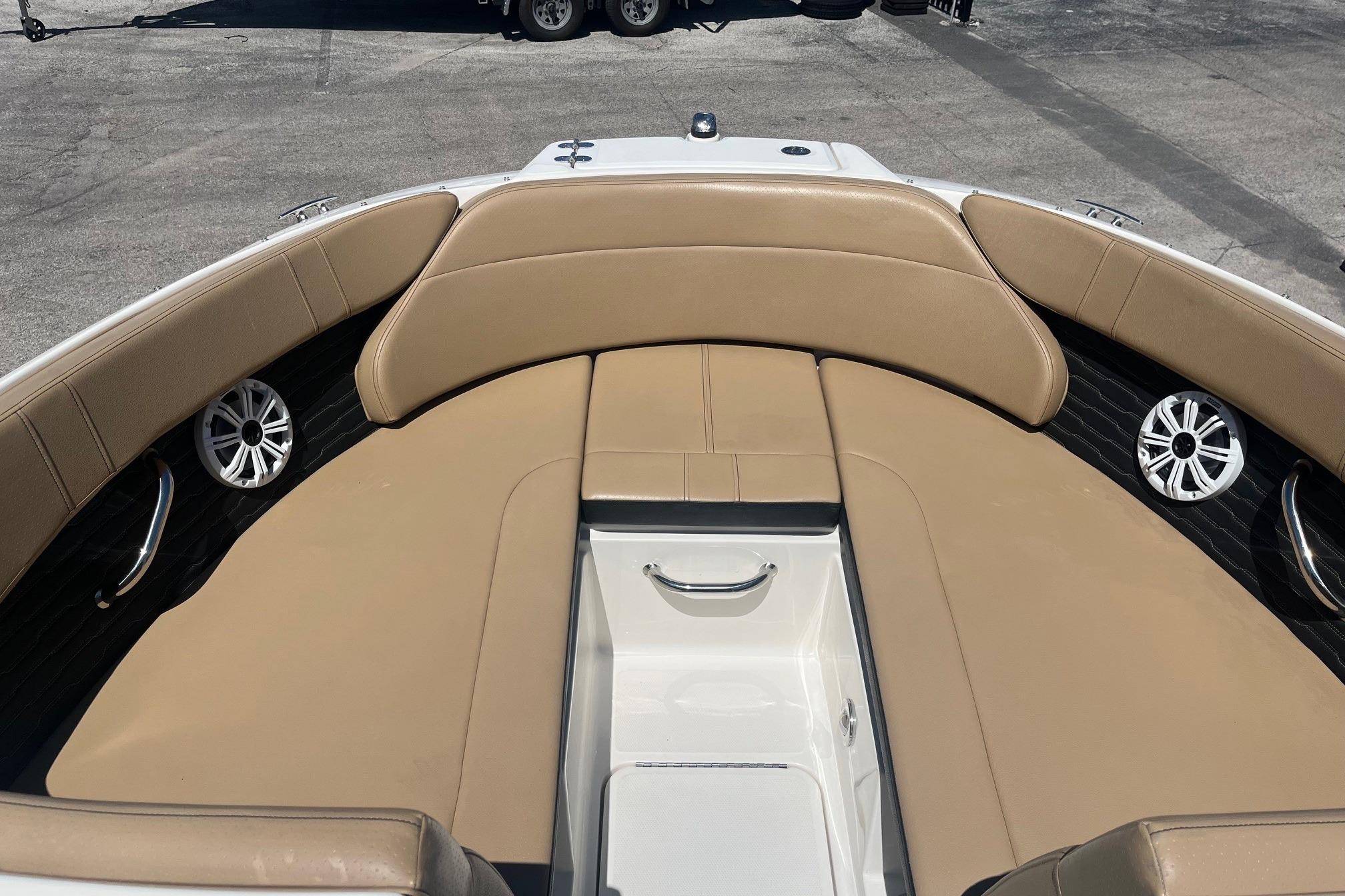 2024 Sea Ray SPX 230 boat interior with tan seating and speakers.