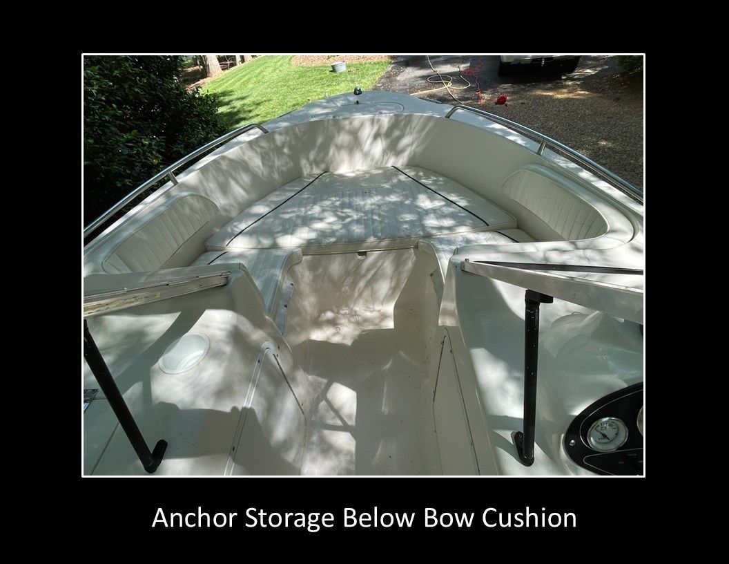 Sea Hunt Escape 2004: Open deck with seating and storage below the bow cushion.