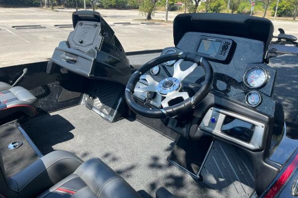 2024 Nitro Z19 boat cockpit with steering wheel, dashboard, and seating.