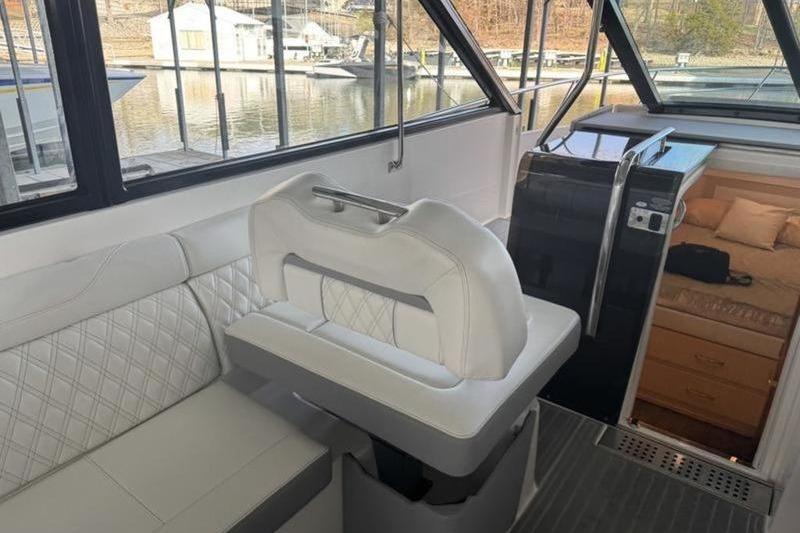 Interior of 2023 Regal 36 Grande Coupe yacht with luxurious seating and cabin view.