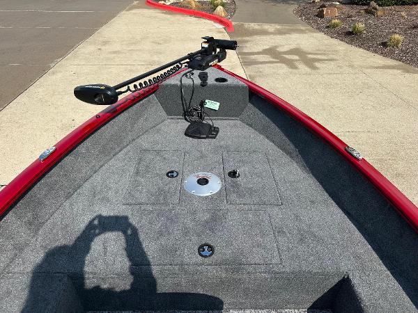 2025 Tracker Super Guide V-16 T boat deck with trolling motor, red trim, and gray carpet.