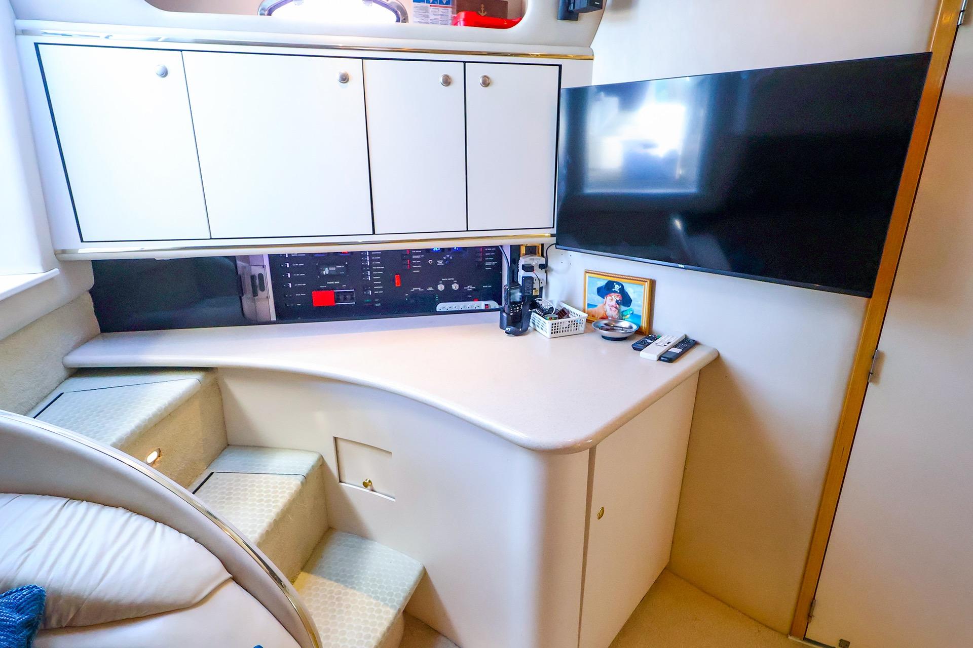 Interior of 1998 Sea Ray 500 Sundancer yacht with cabinets and entertainment setup.