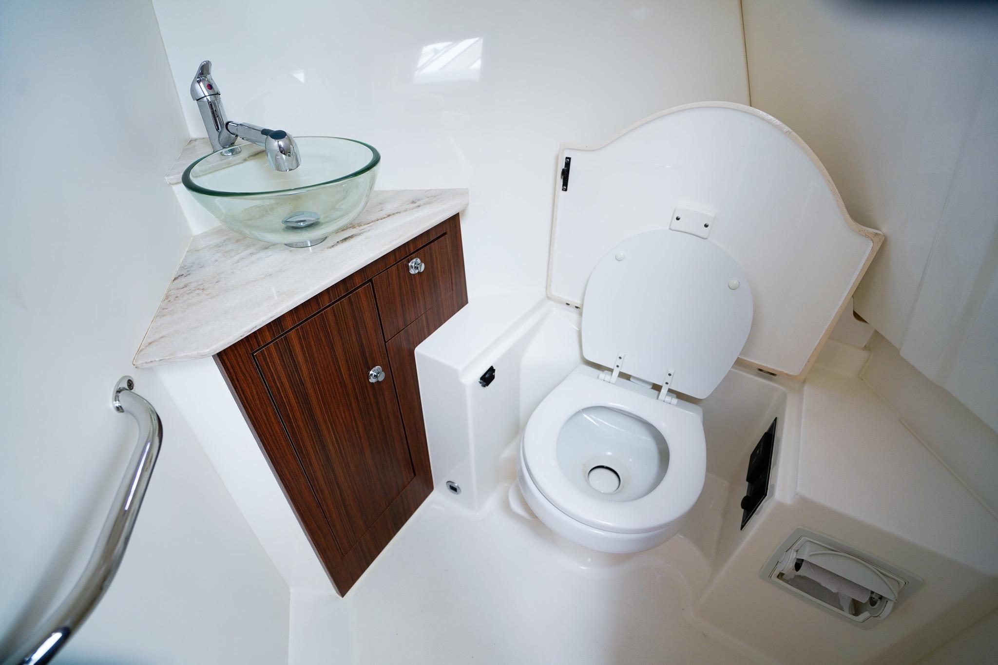 2020 Pursuit OS 325 Offshore boat bathroom with modern sink and toilet.