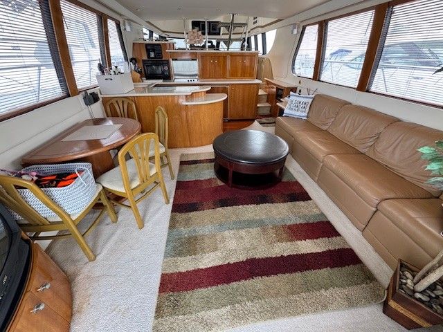 Interior of a 2002 Carver 570 Voyager Pilothouse yacht with cozy living area.
