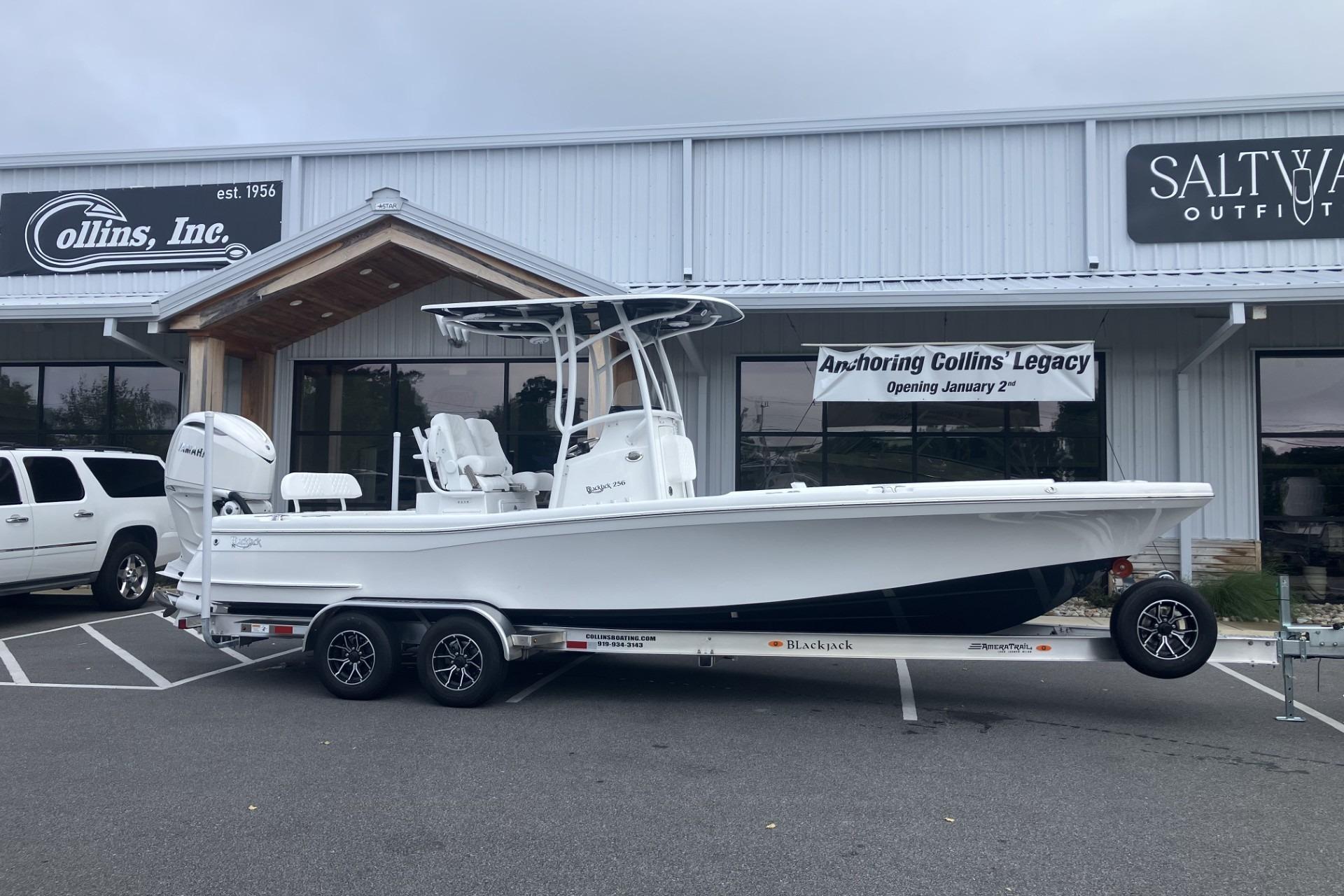 2026 BlackJack 256 Coastal boat on trailer outside Collins Inc. store.