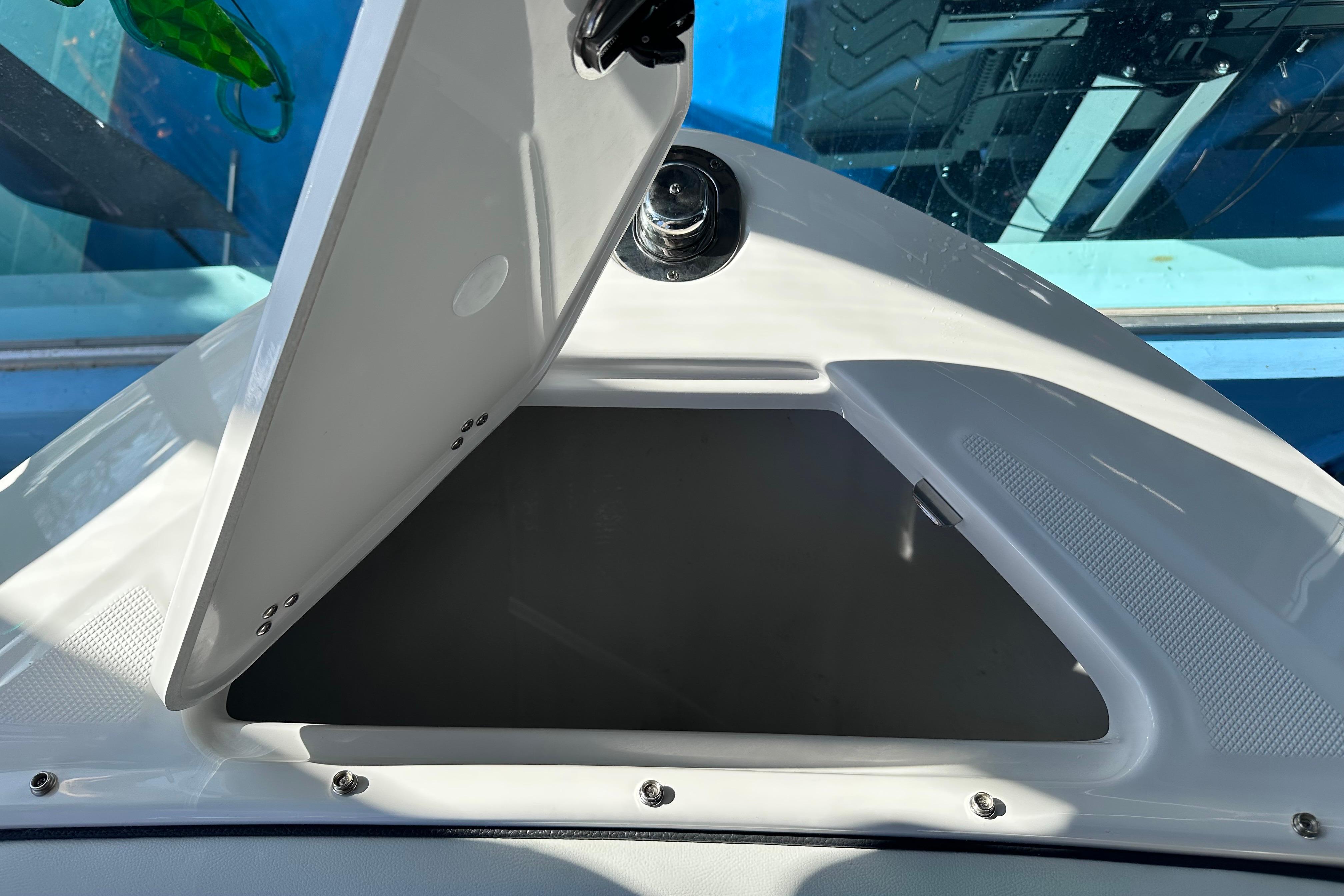 Open storage compartment on 2026 Regal LX4 boat, showcasing sleek design and functionality.