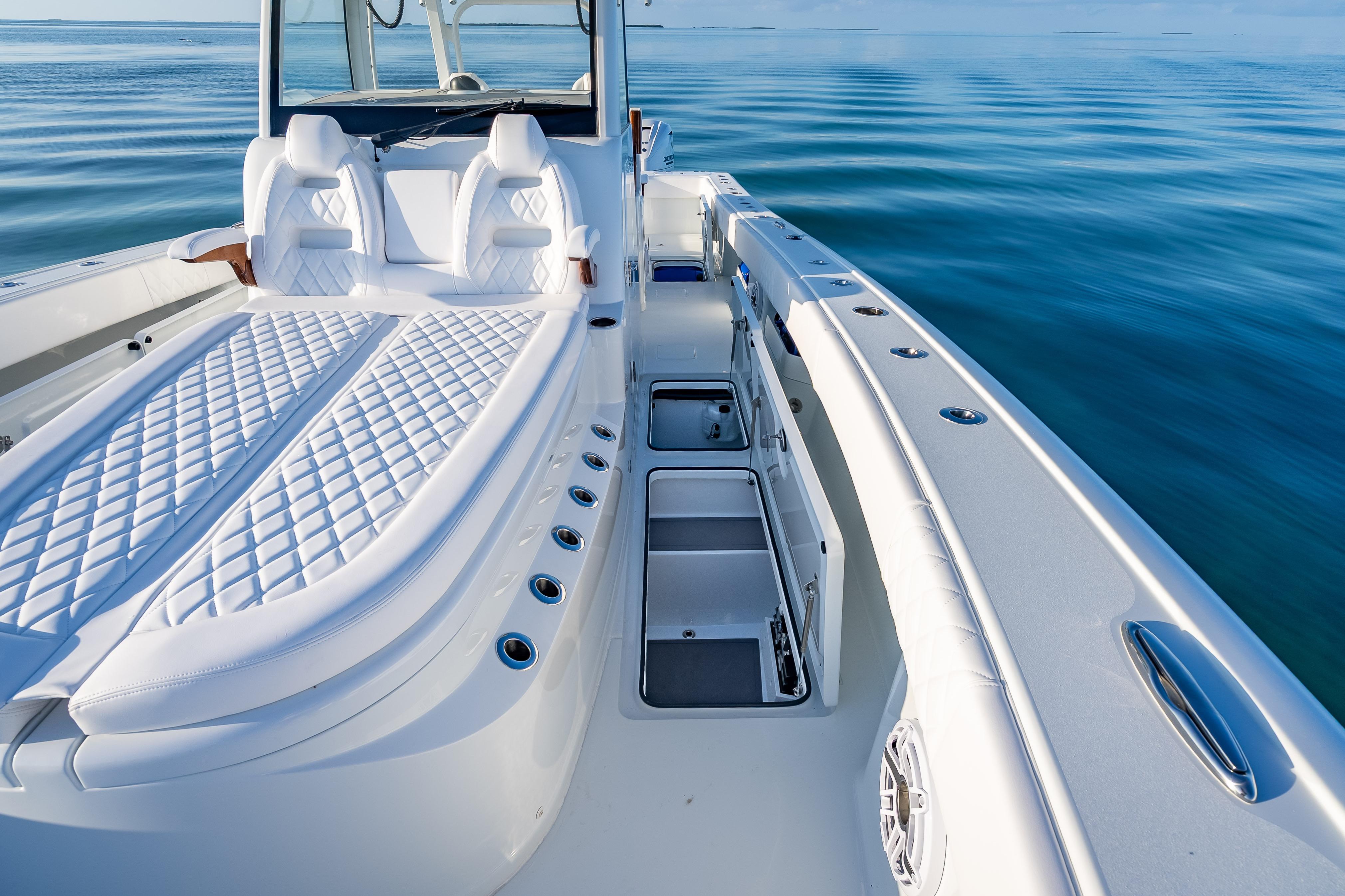 Luxurious 2026 Freeman 35 boat interior with white seating and open storage compartments.