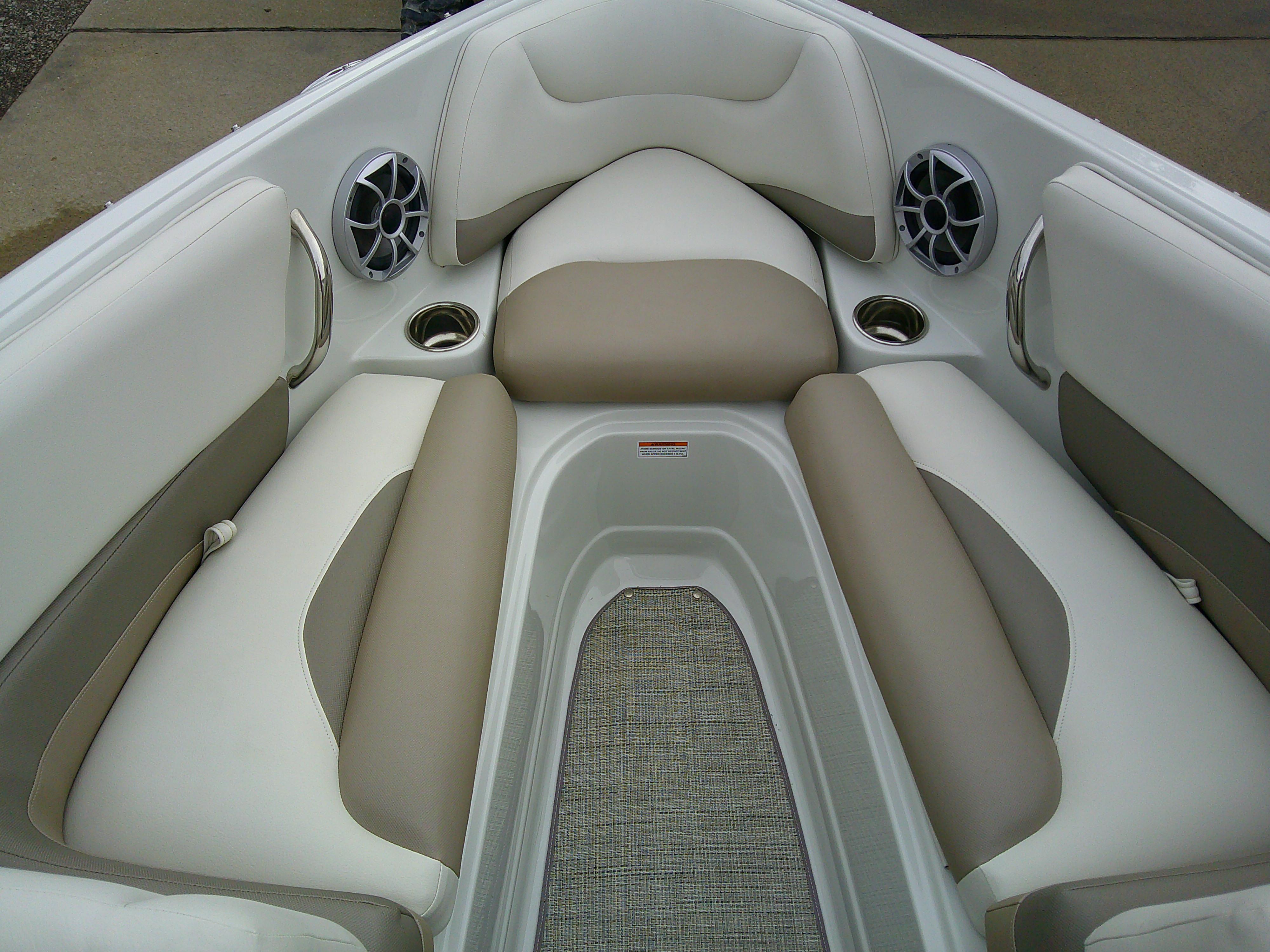 2019 Crownline 19 XS boat interior with beige and white seating, cup holders, and speakers.