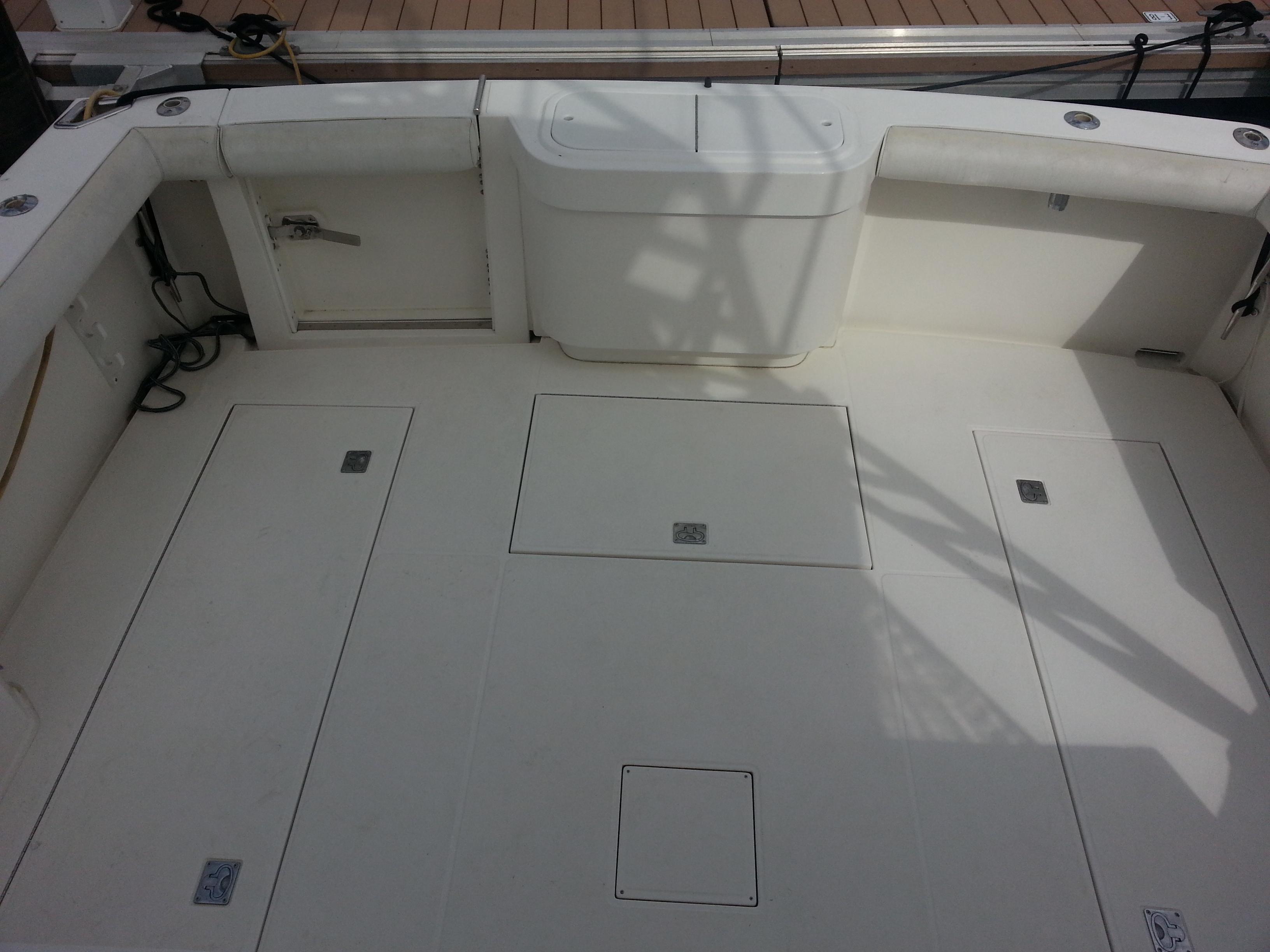 2001 Cabo 35 Express boat deck with storage compartments and seating.