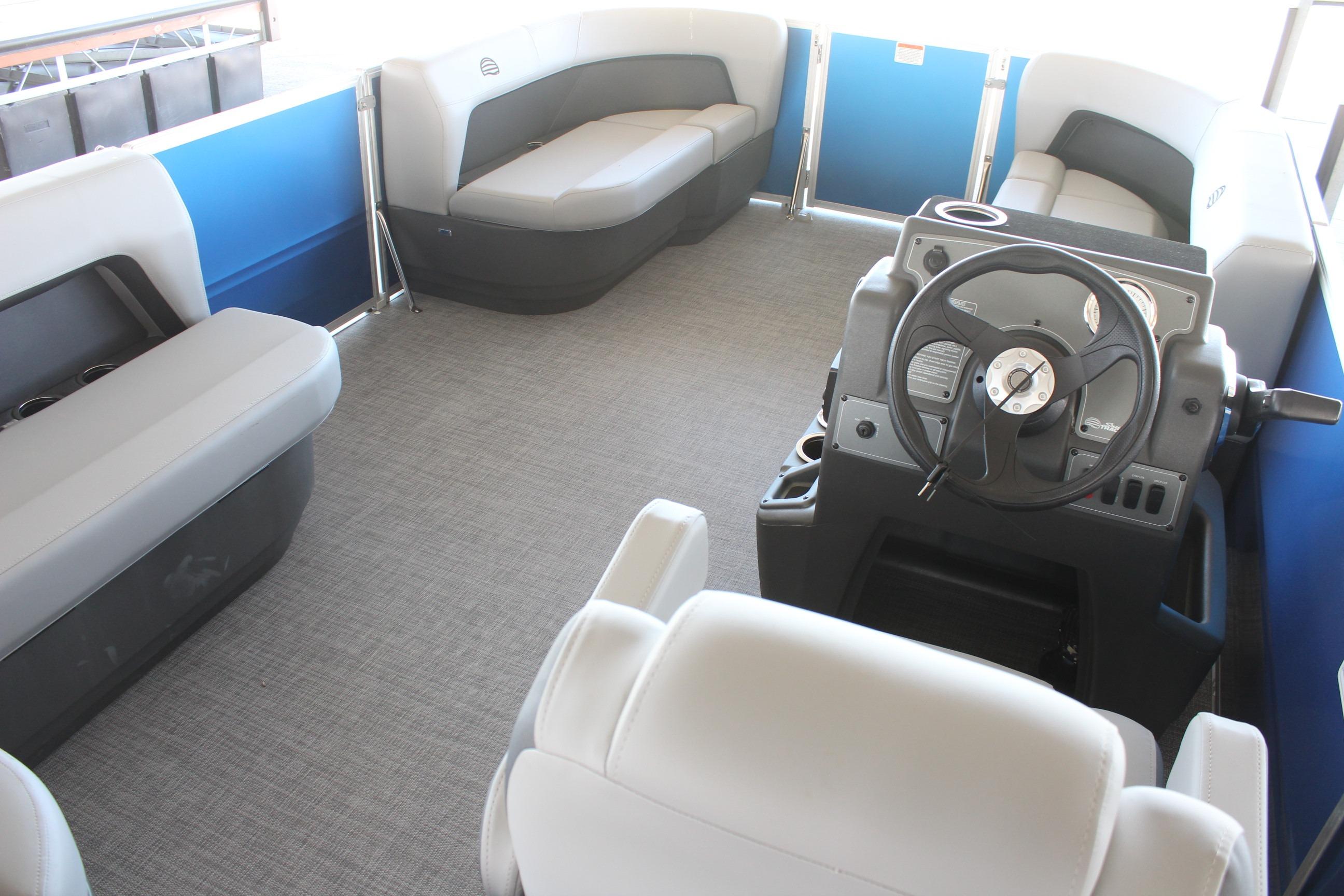 Interior of 2026 Sun Tracker Party Barge 16 DLX with seating and steering console.