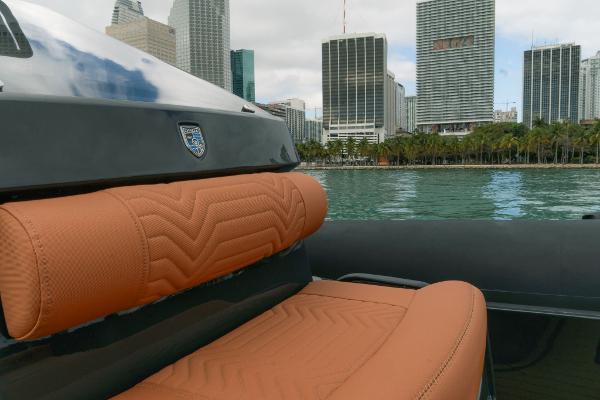 2024 Onda Magna boat with tan leather seats, city skyline in background.