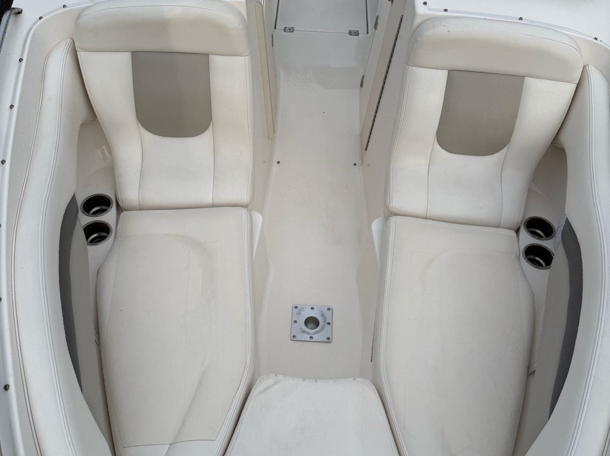 The image shows the interior of a 2007 Chaparral 256 SSX with white seating.