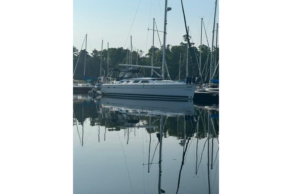 2009 Hunter 41 Deck Salon sailboat docked in a serene marina setting.