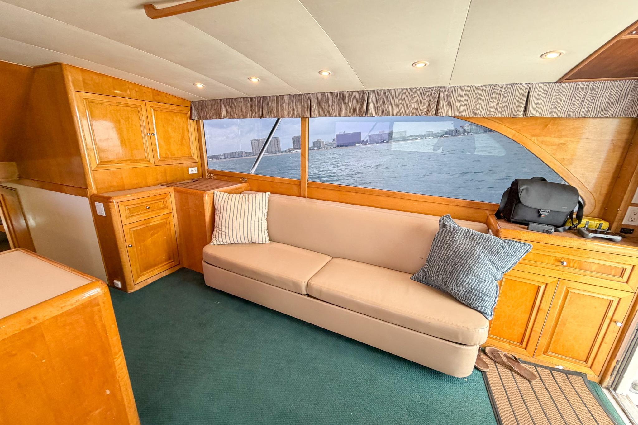 Luxurious interior of 1998 Blackwell Custom Carolina Sportfish yacht with sofa and ocean view.