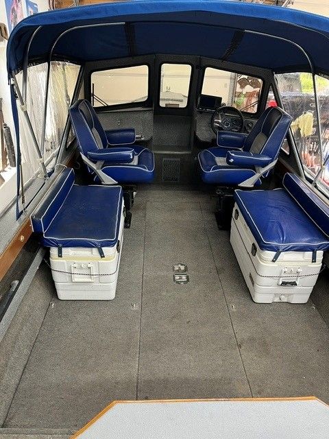 Interior of a 1986 custom jet boat with blue seating.