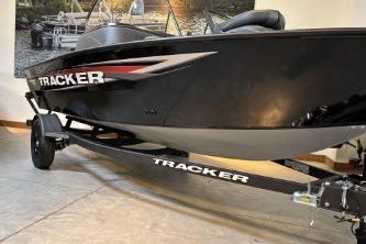 2026 Tracker Pro Guide V-16 WT boat on trailer in showroom.