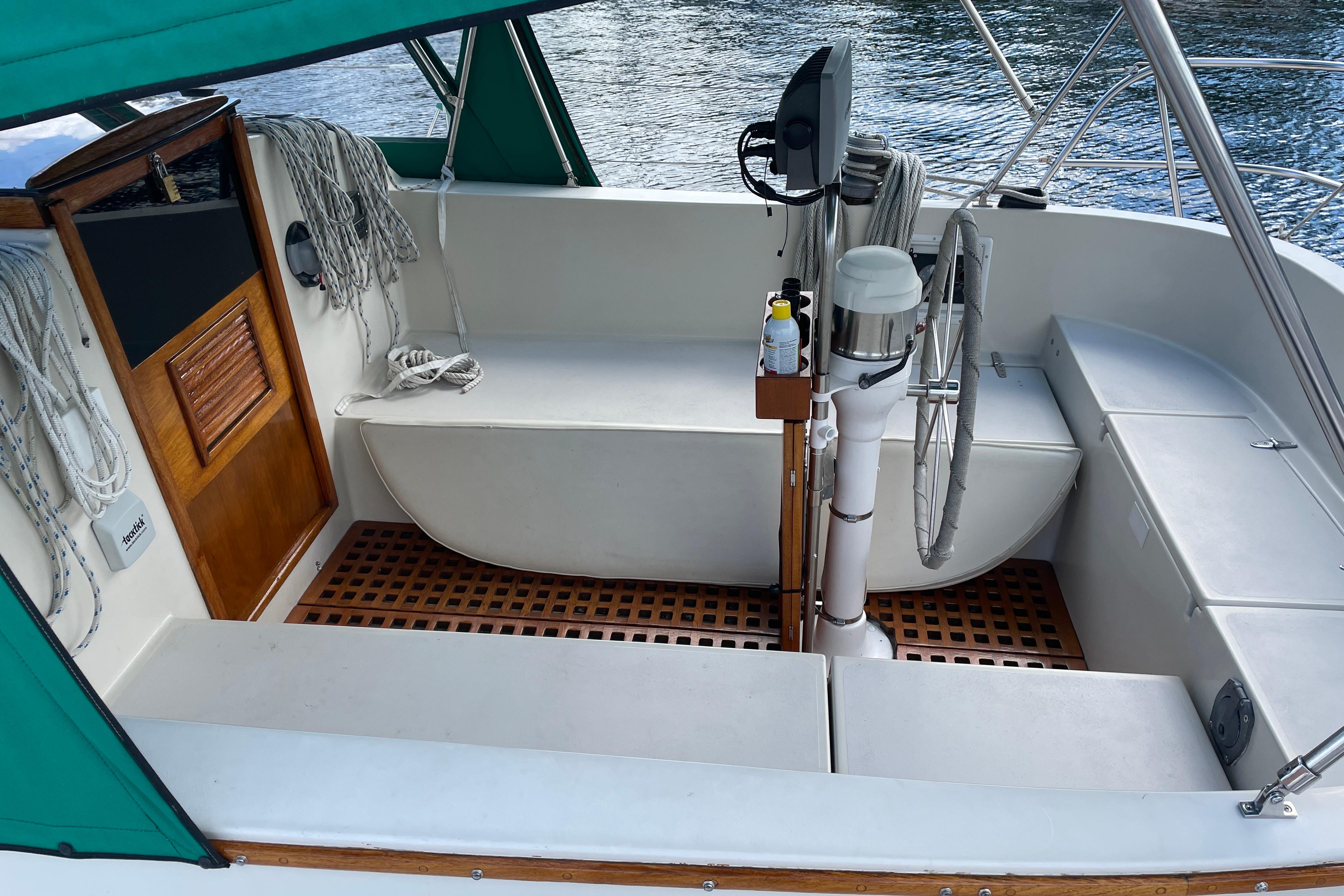 1981 Nonsuch 30 Classic sailboat cockpit with green canopy and wooden accents.