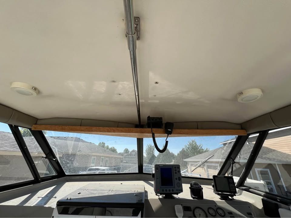 Interior view of a 1999 Bayliner 2452 boat cockpit with control instruments.