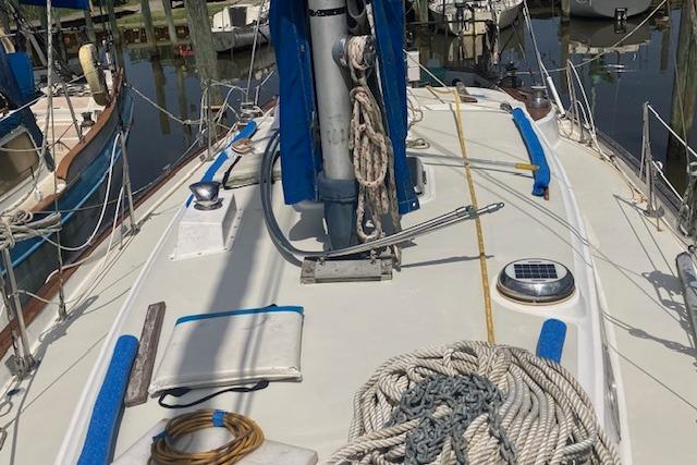 1979 Pearson 365 Ketch sailboat deck with ropes and equipment in marina.