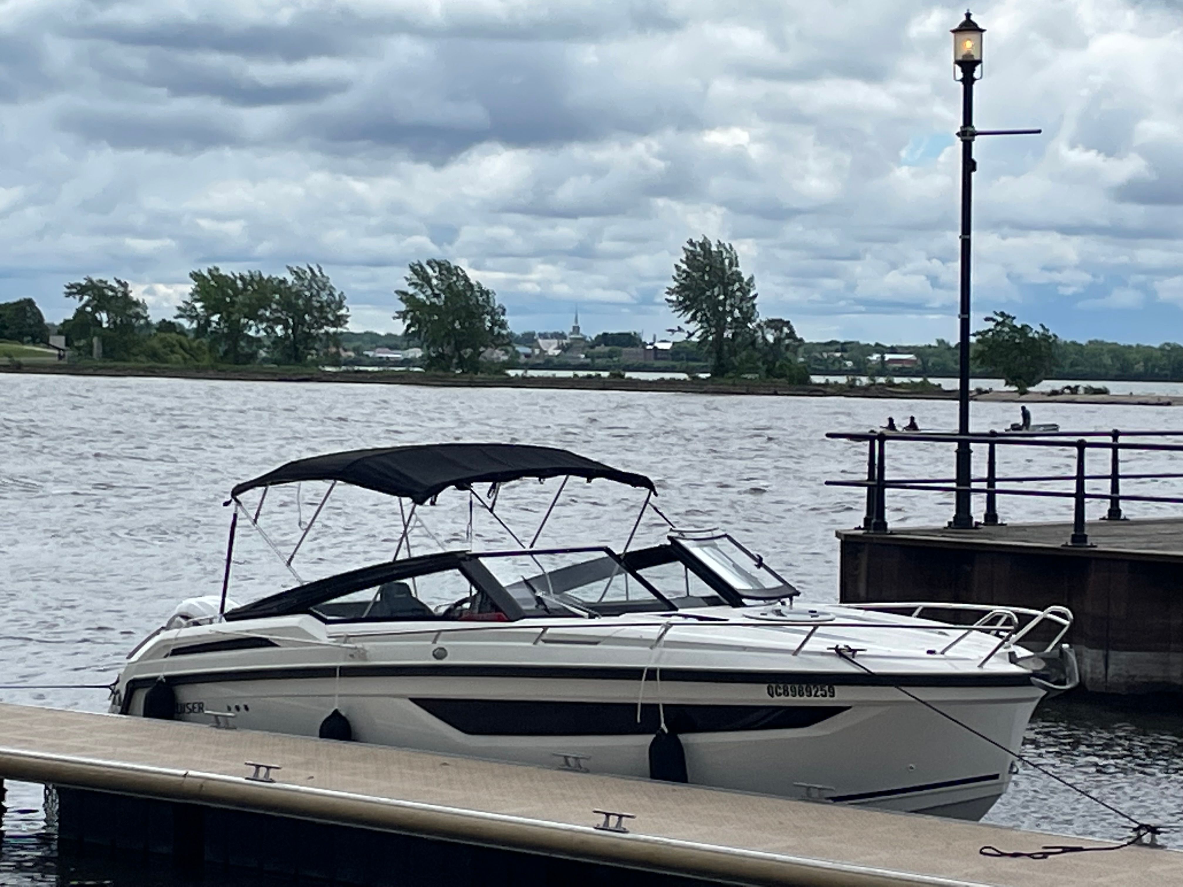 A 2022 Parker Poland 800 Cruiser docked on calm waters under a cloudy sky.