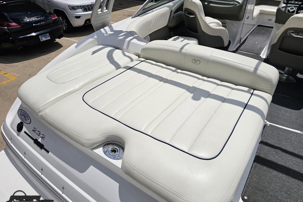 2010 Cobalt 232 WSS boat with white leather seating and sleek interior design.
