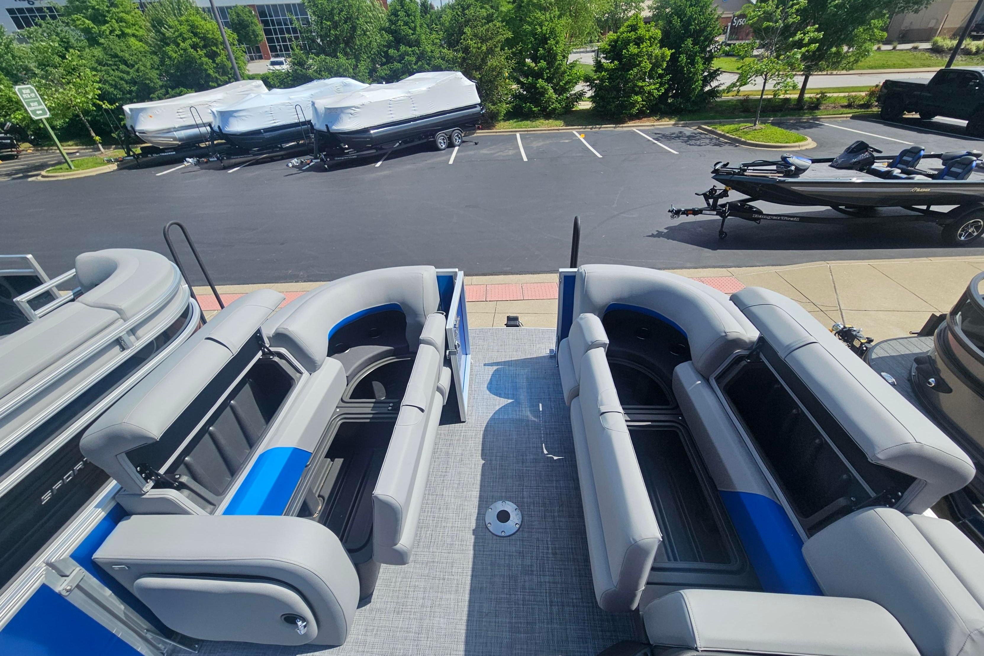 2026 Sun Tracker Party Barge 22 RF DLX with spacious seating, parked outdoors.