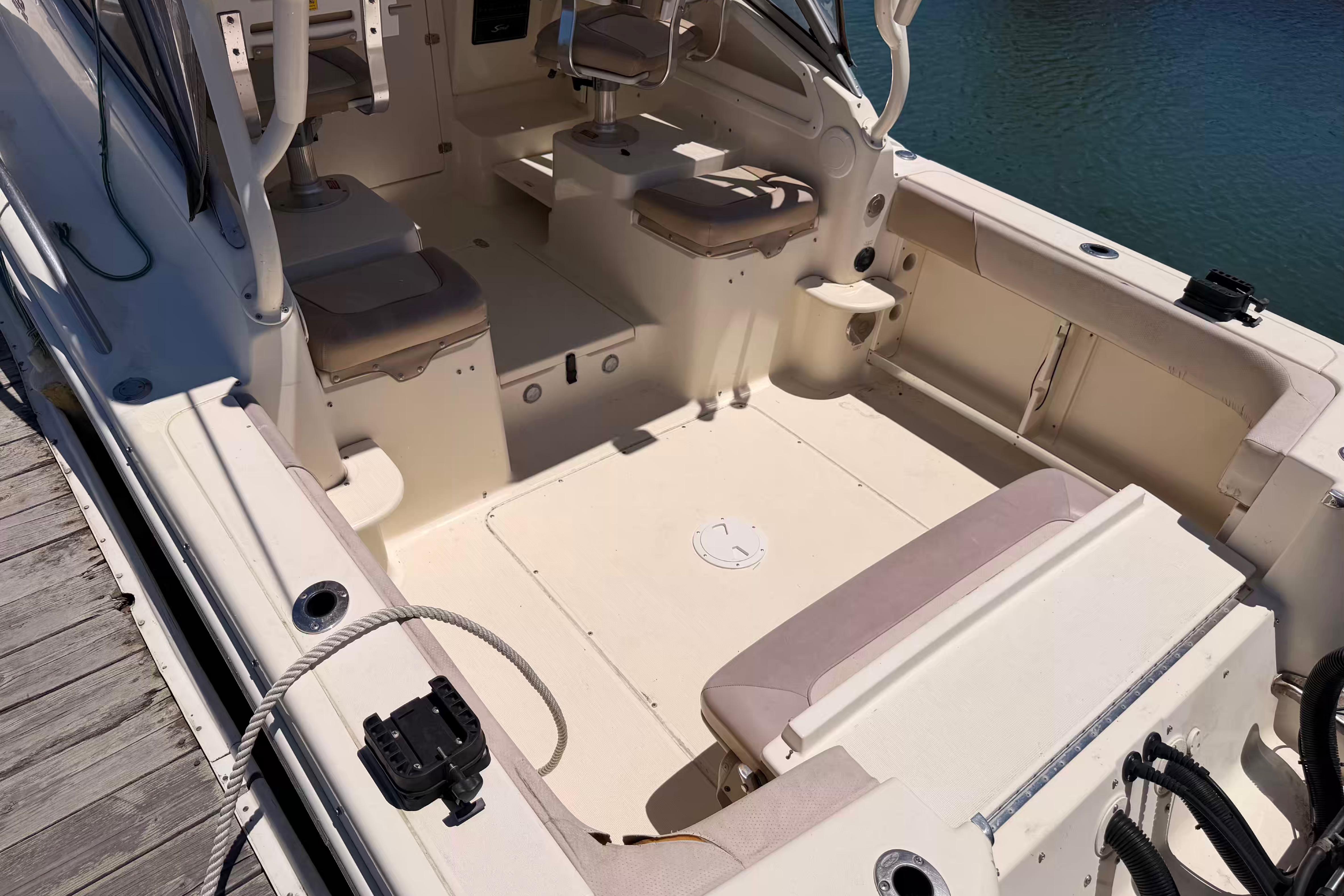 2007 Scout 262 Abaco boat interior with seating and helm, docked by the water.