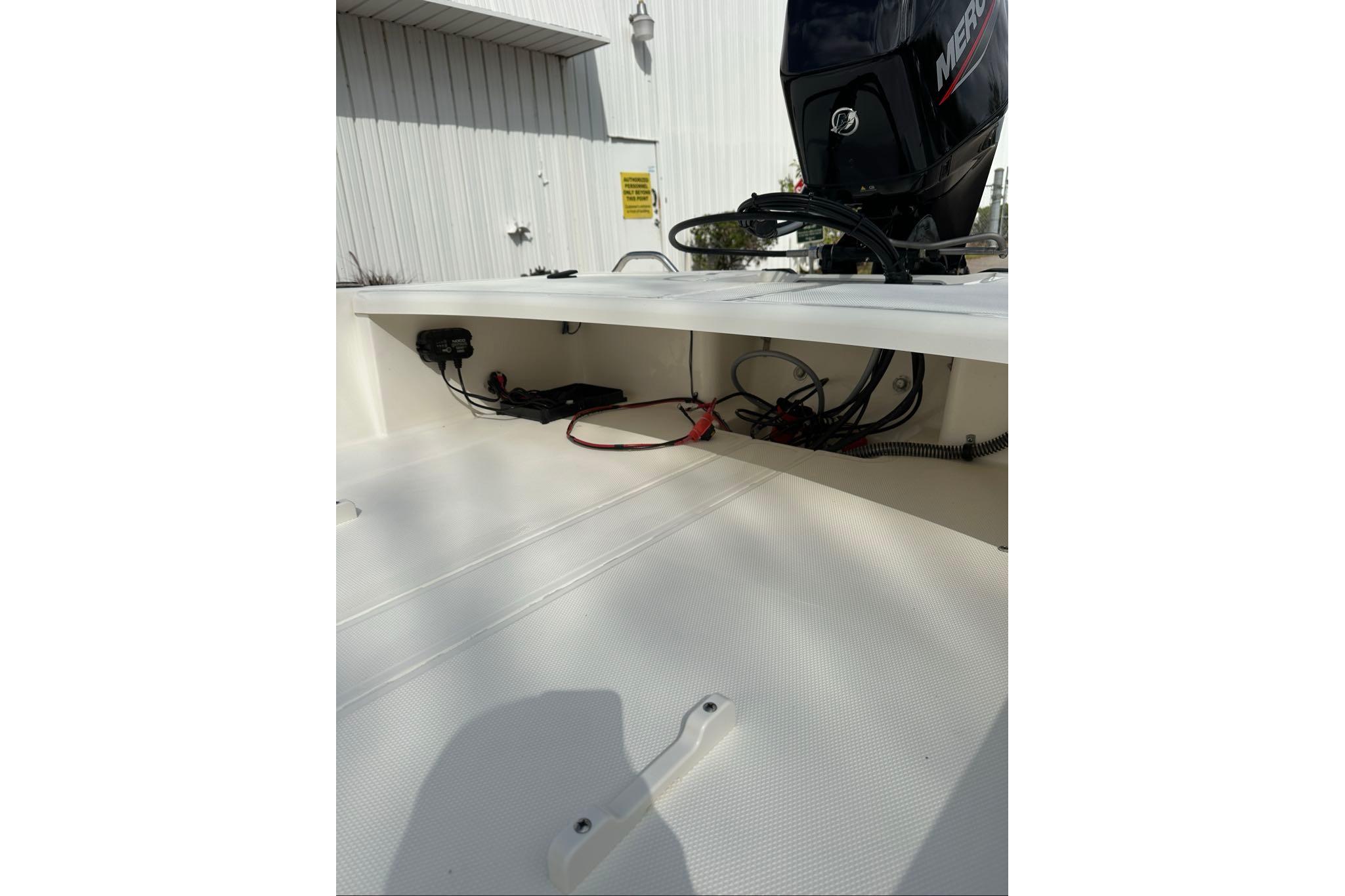 2026 Mako Pro Skiff 17 CC boat interior with visible wiring and Mercury engine.