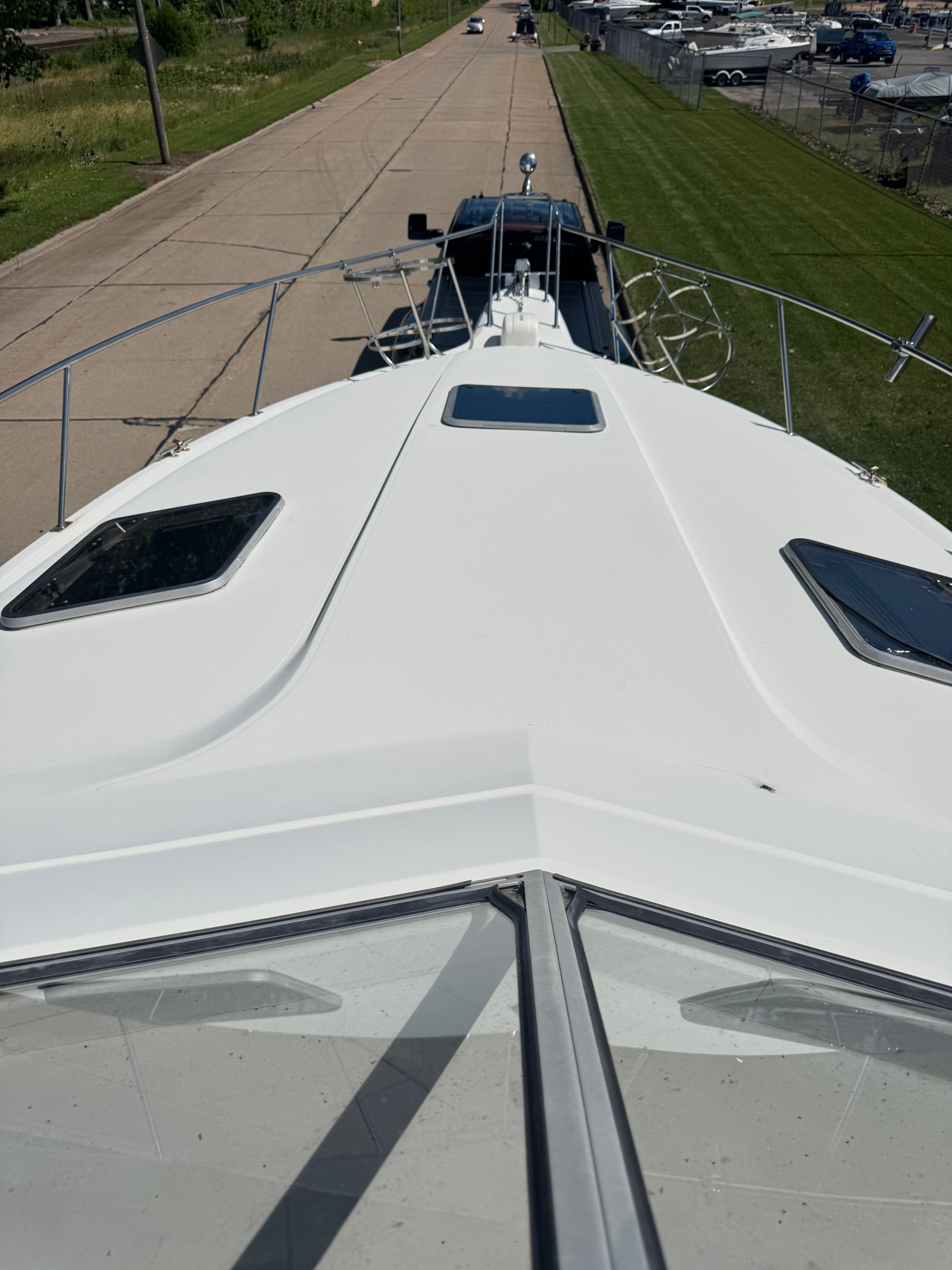 The 1992 Cruisers Yachts Esprit 3370 is on a trailer on a road.