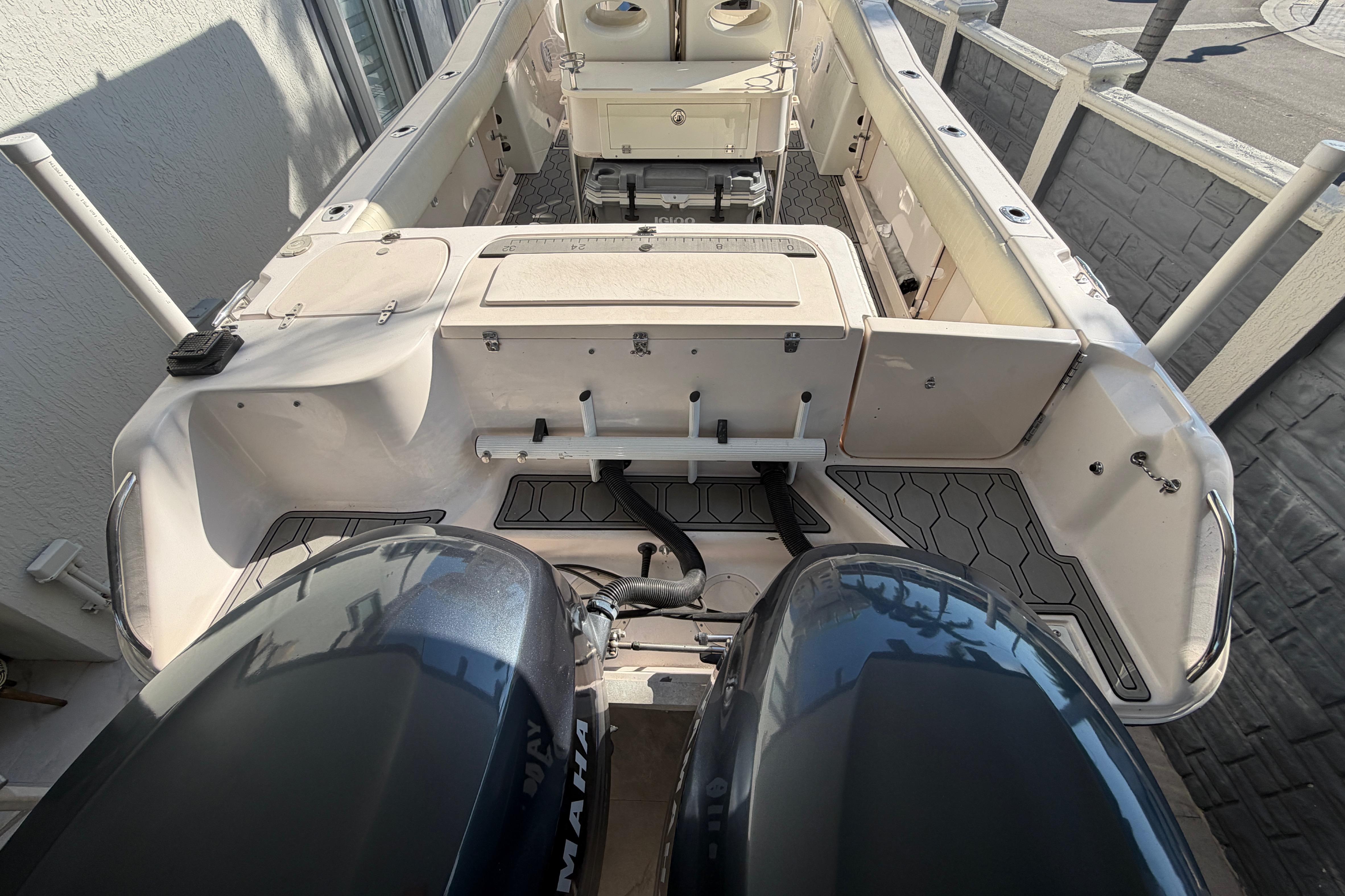 2004 Grady White 273 boat interior with dual Yamaha engines, docked outdoors.