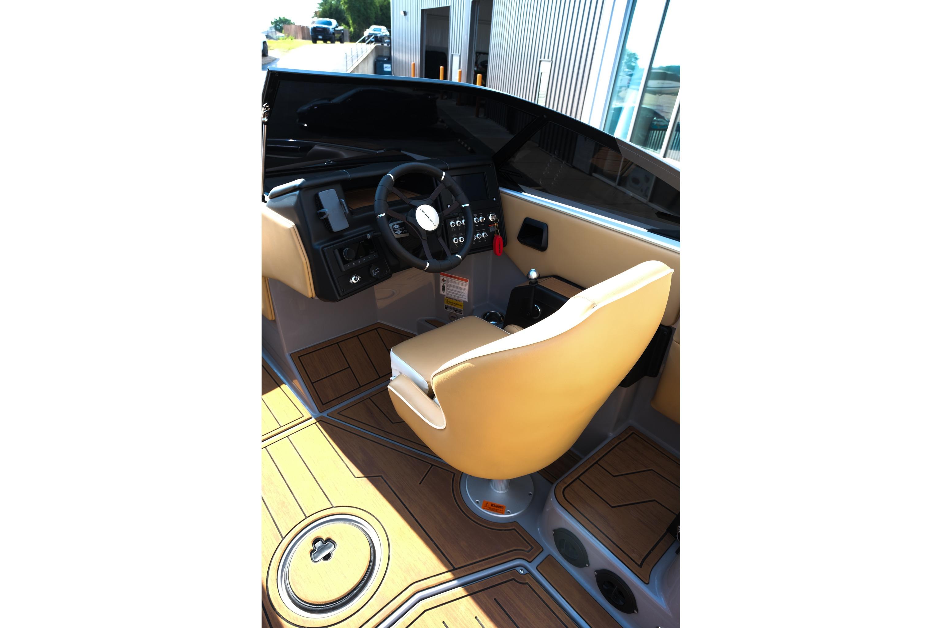 2023 Moomba Mondo boat interior with tan seating and modern dashboard controls.
