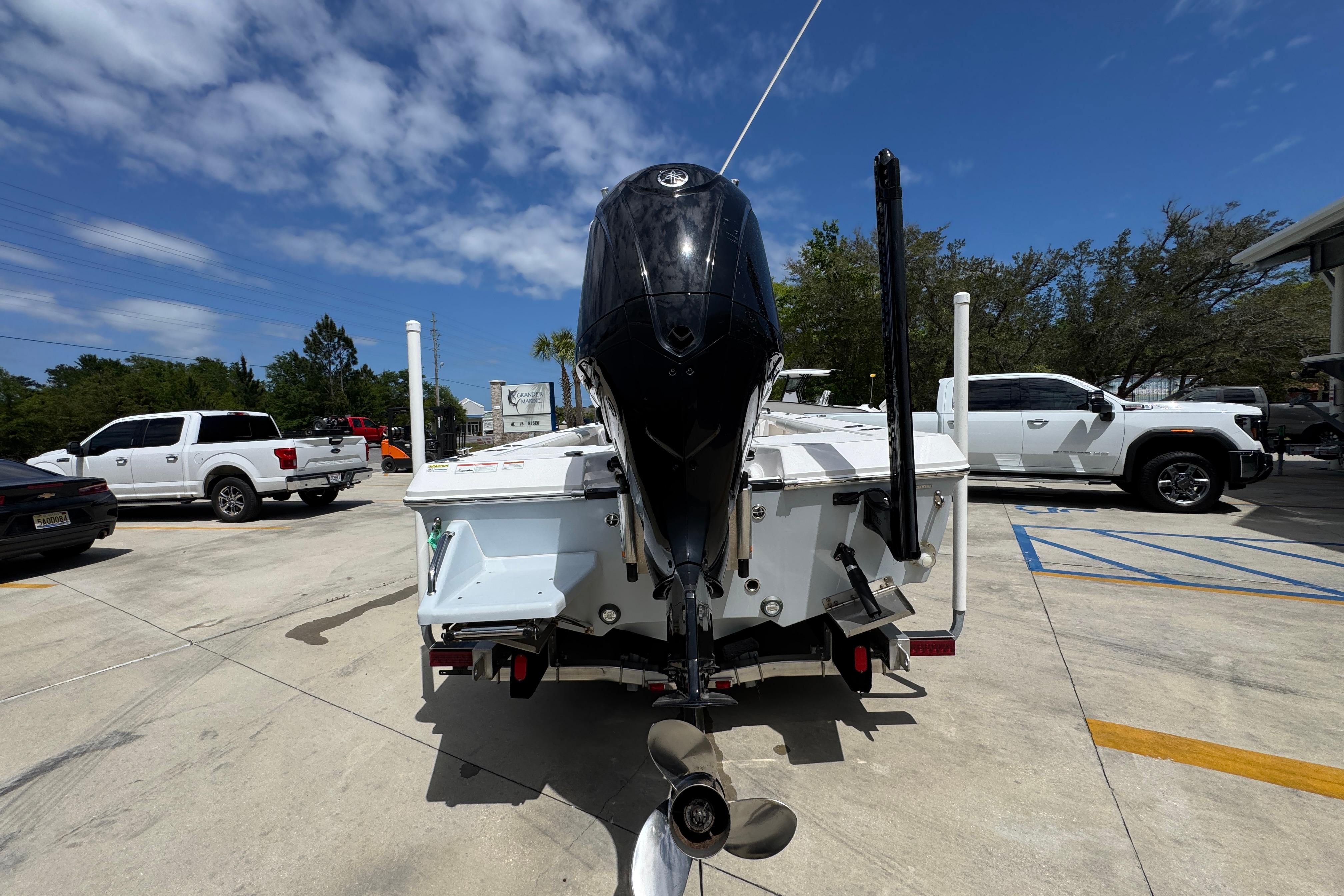 2022 Everglades 243 Center Console boat with outboard motor in a parking lot.