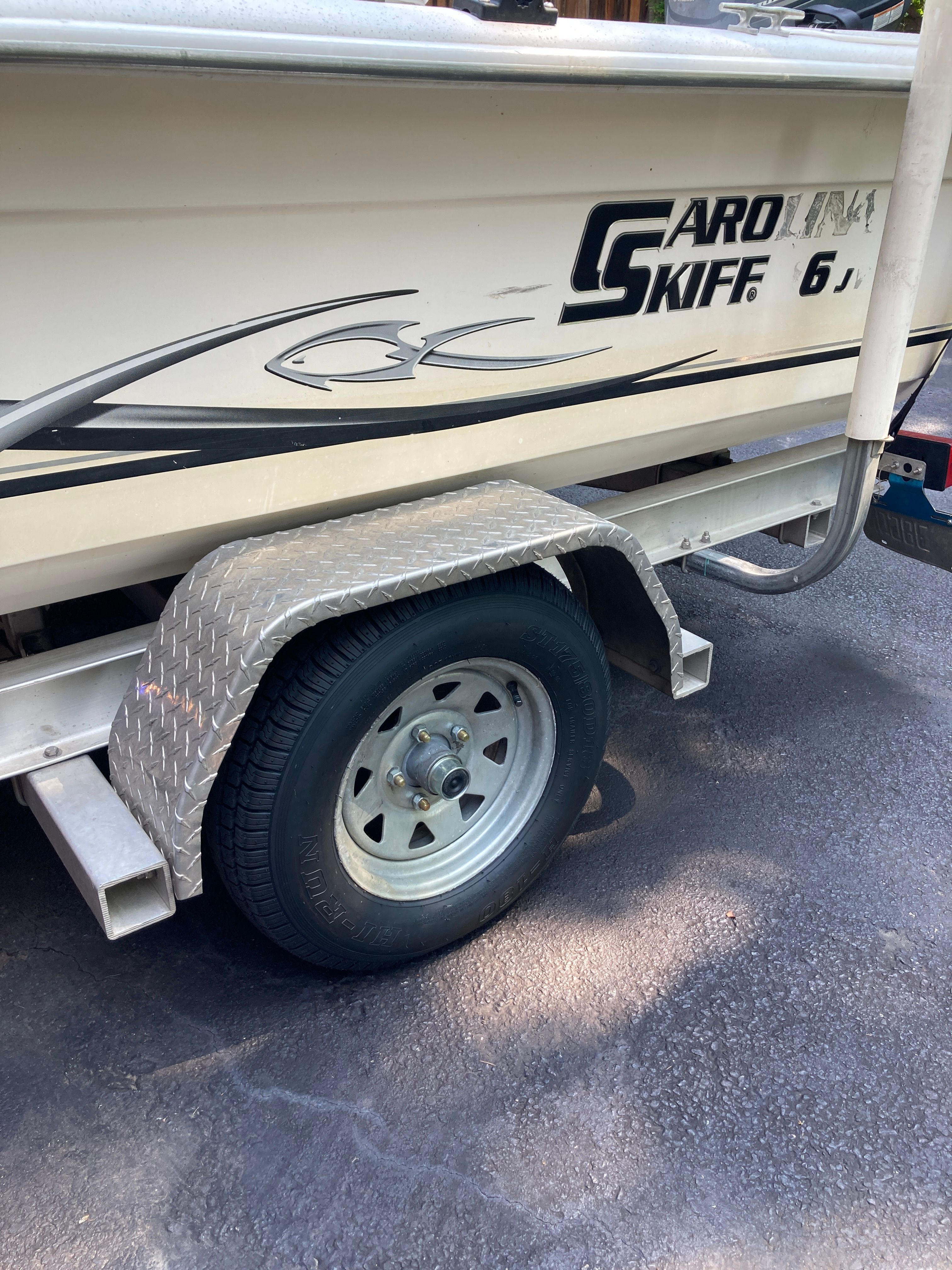 A 2012 Carolina Skiff JVX16CC boat on a trailer with diamond-patterned fenders.