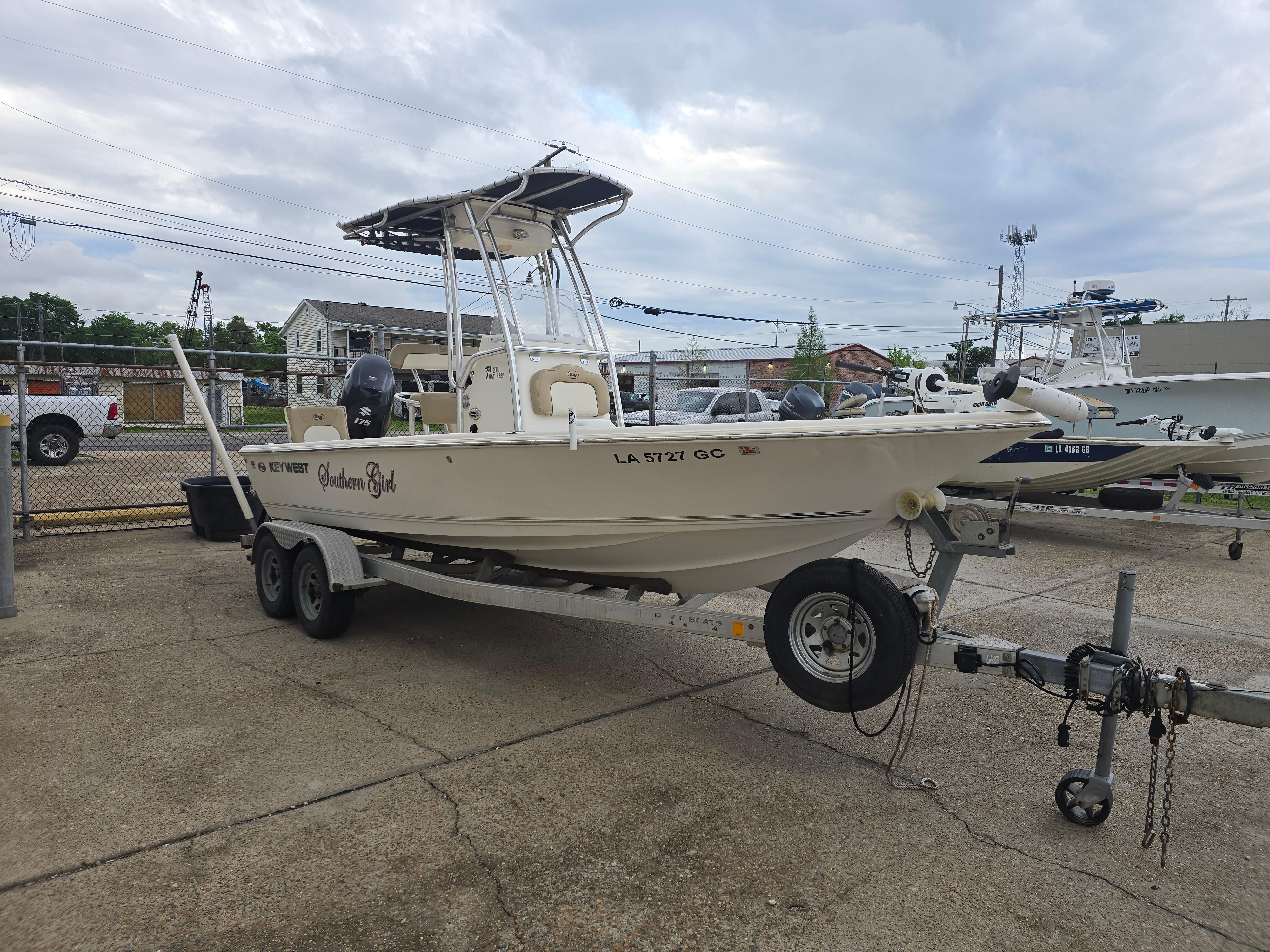 2014 Key West 210 Bay Reef boat on trailer, parked outdoors.