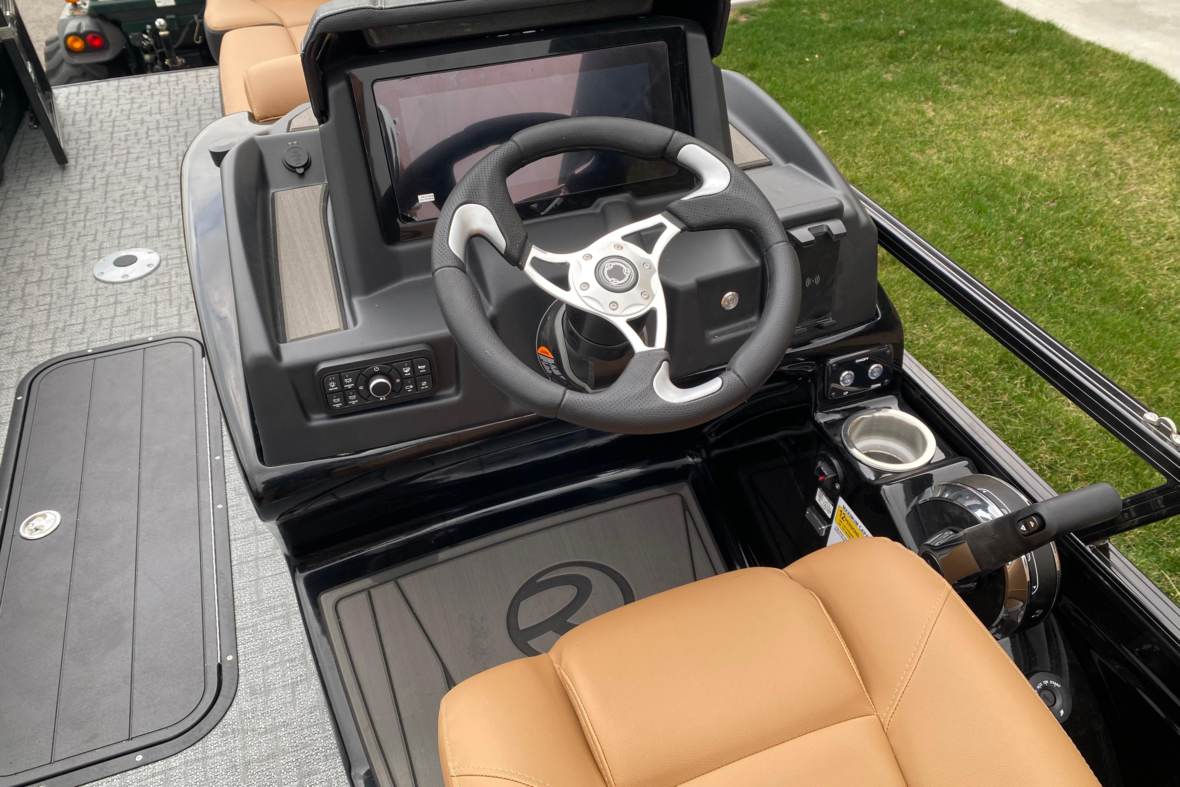 2026 Regency 230 DL boat dashboard with steering wheel and control panel.