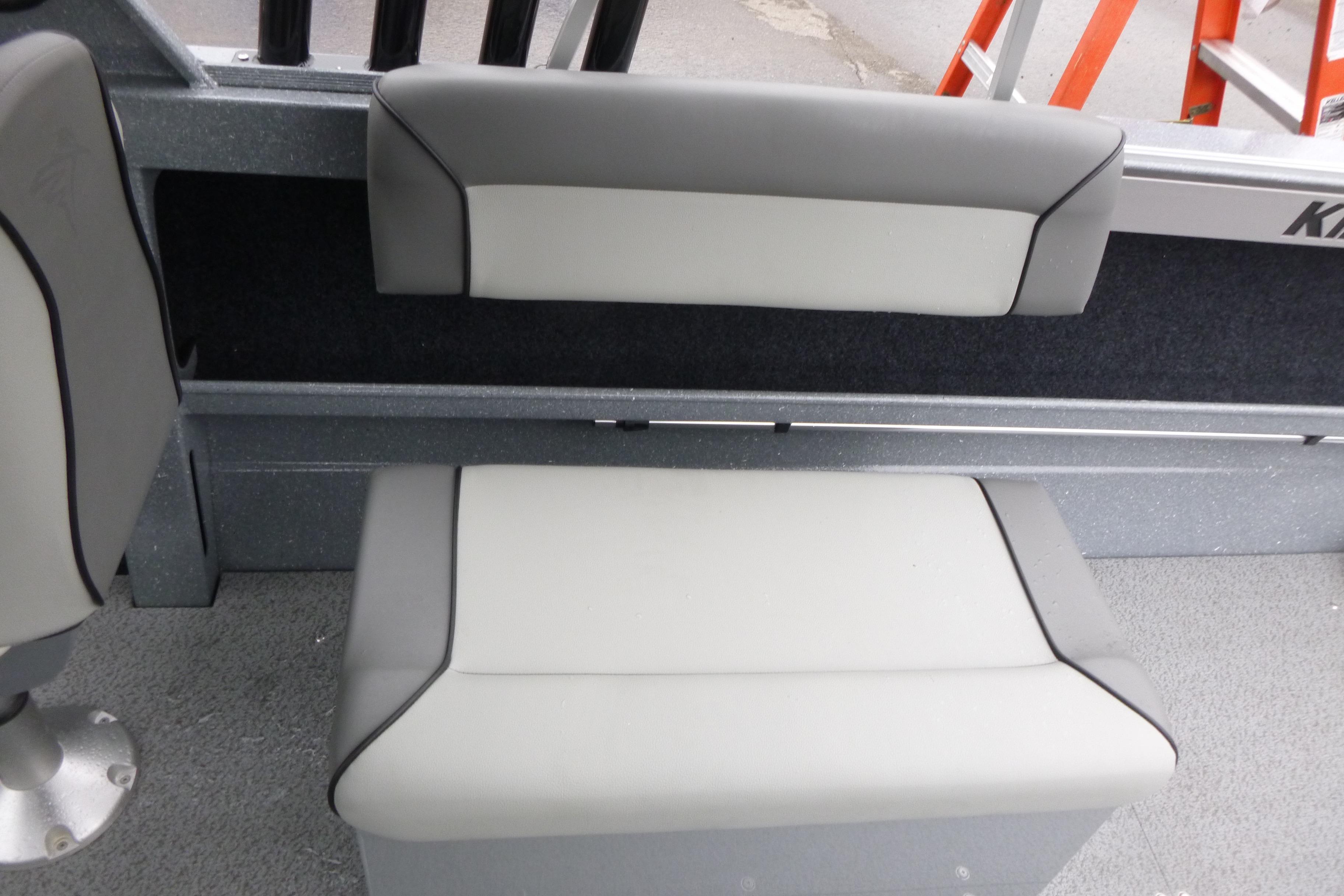 Interior seating of 2026 KingFisher 2025 Escape boat, featuring gray and white upholstery.